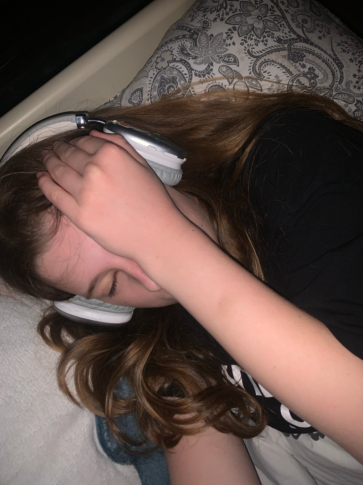 Person relaxes with headphones and yogurt in Belgrade bedroom