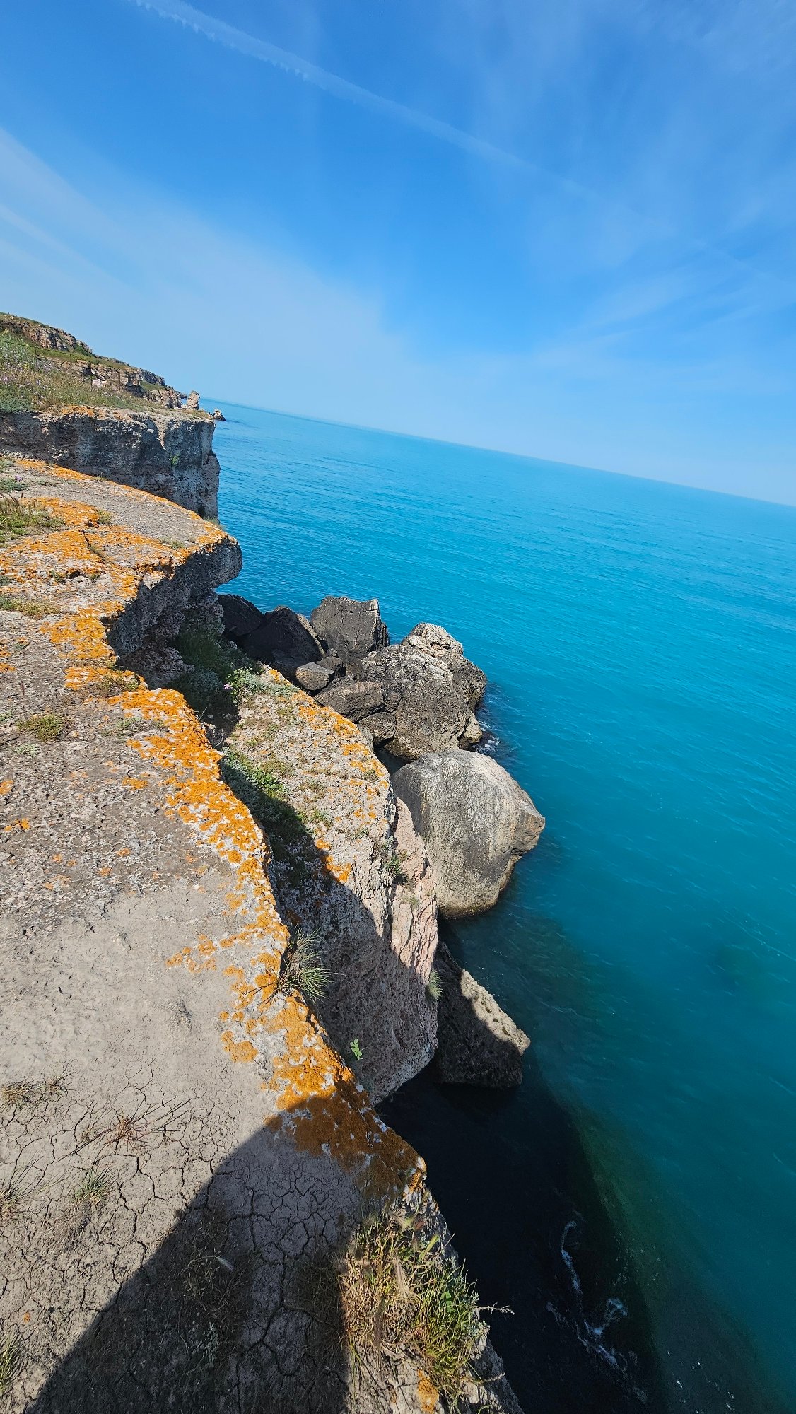 Tourists explore scenic Kamen Bryag cliffs overlooking Black Sea