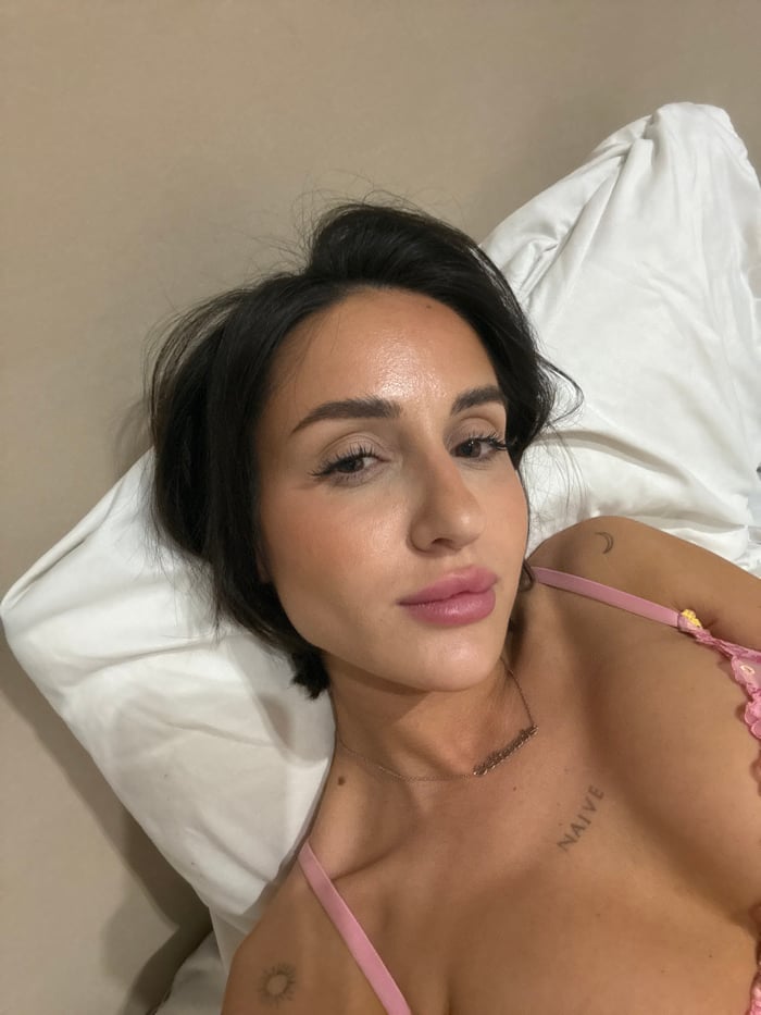 Woman with tattoos resting on pillow in Khimki