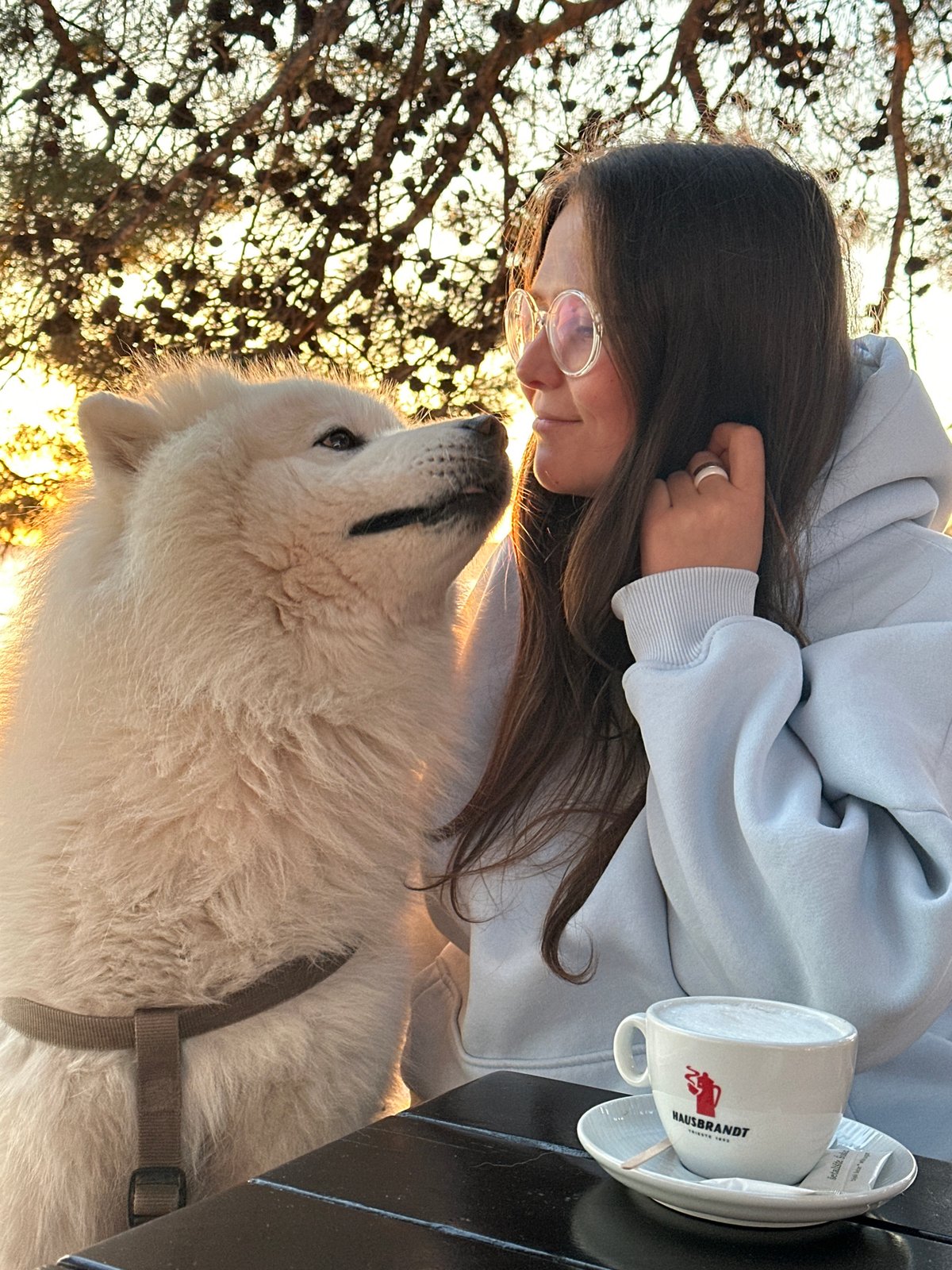 Woman and white dog enjoy golden hour sunset in Montenegro