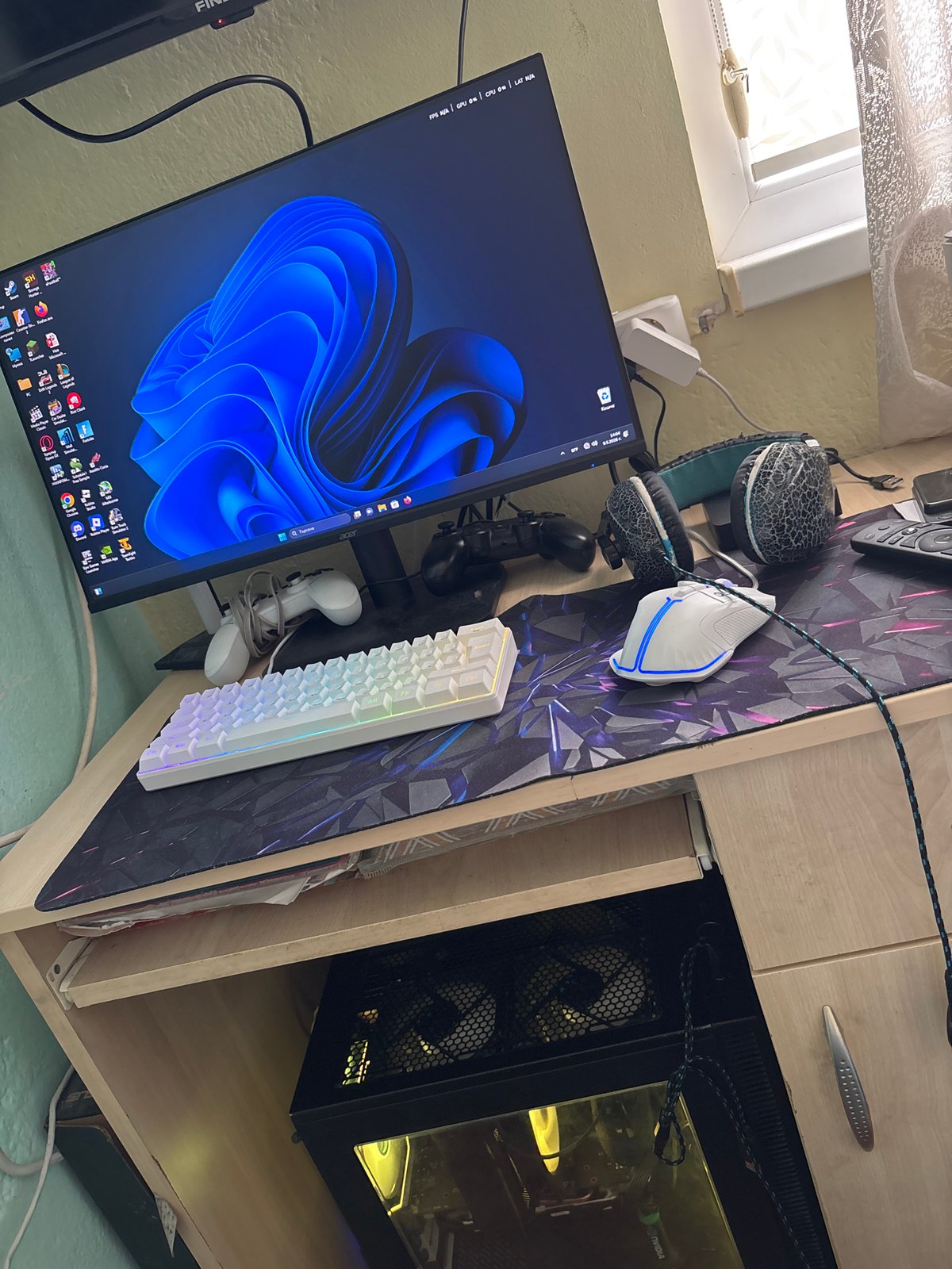 Computer setup documented in cluttered indoor room