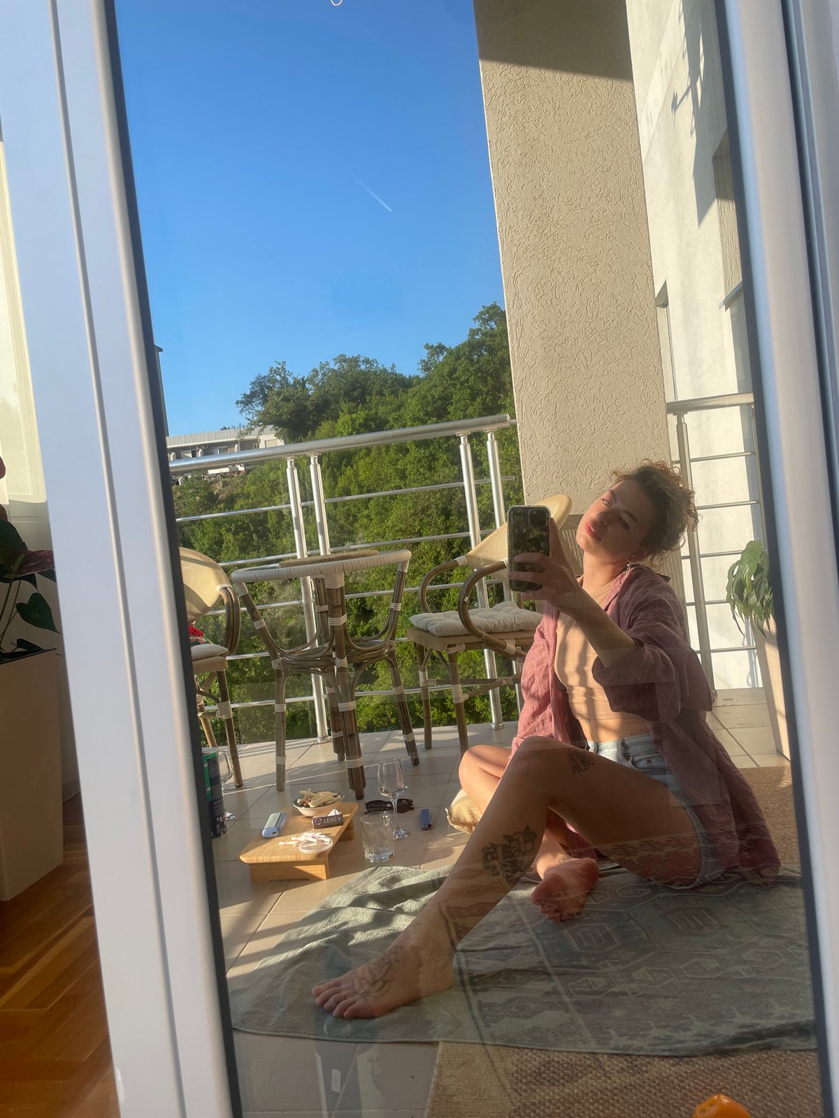 Woman takes selfie on balcony in Rafailovići, Montenegro