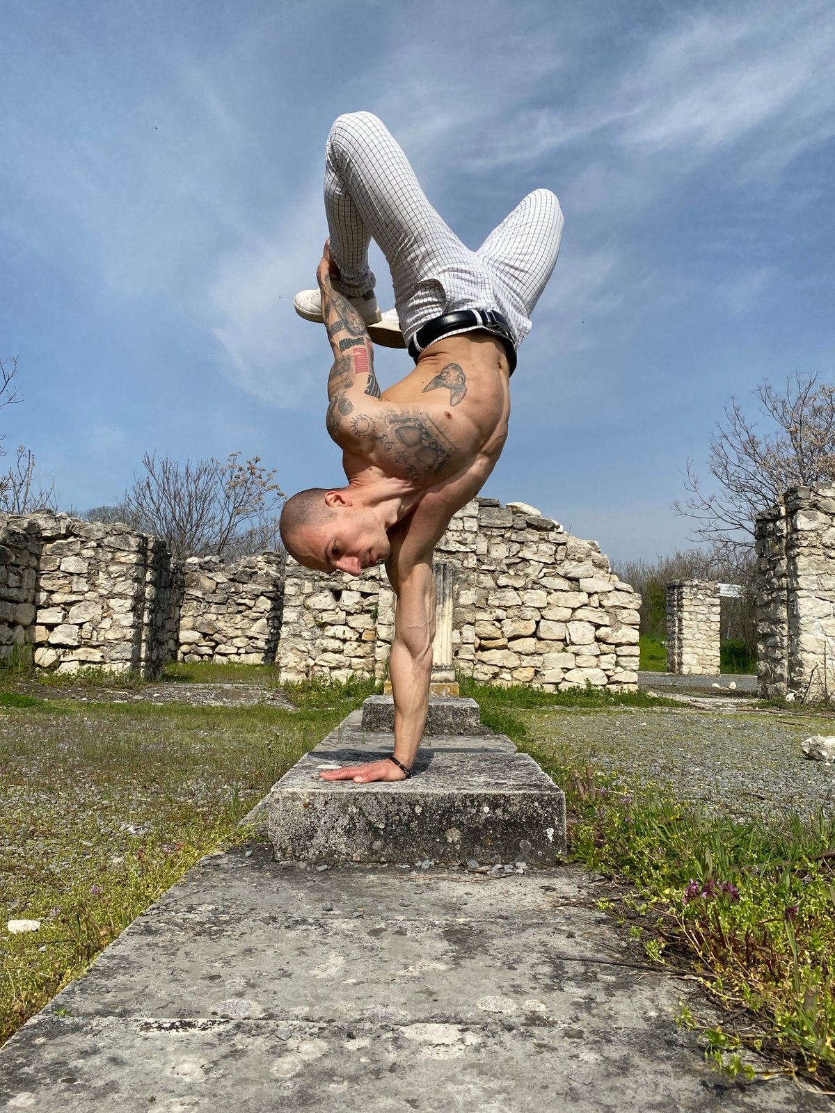 Man performs gymnastics on stone ruins in Pleven