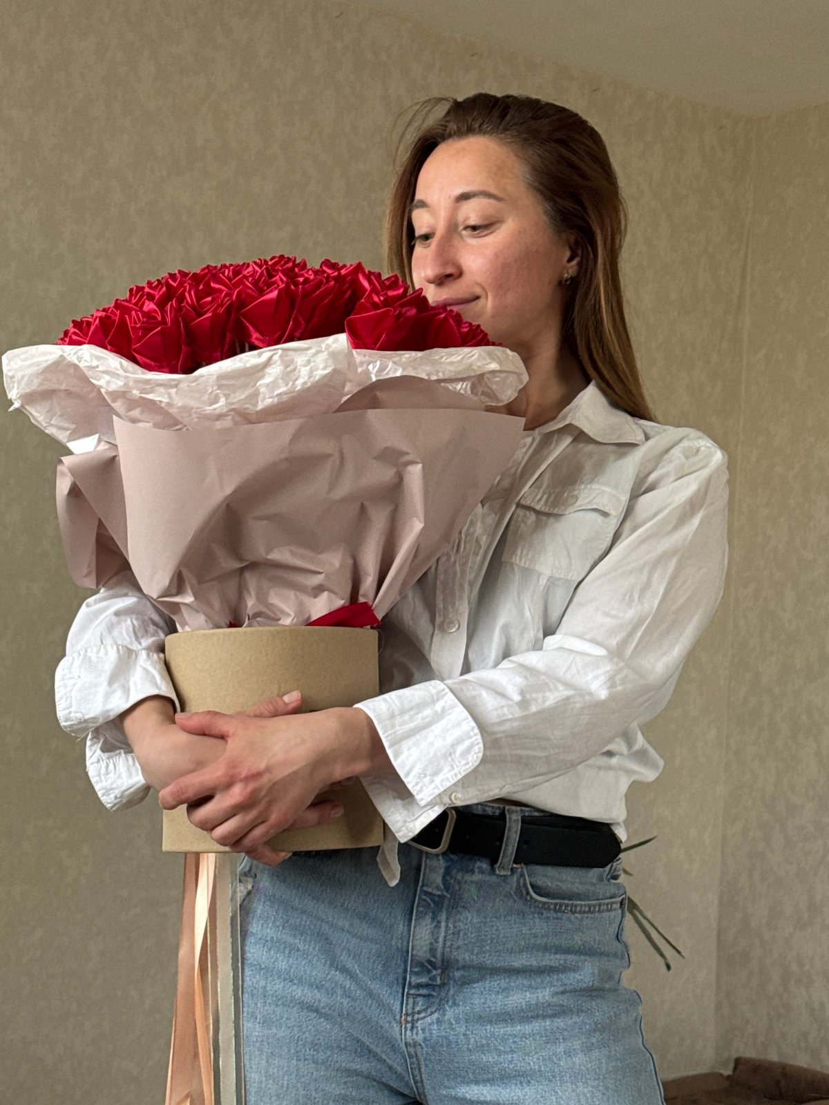 Woman enjoys red flower bouquet in Прикамский, Russia
