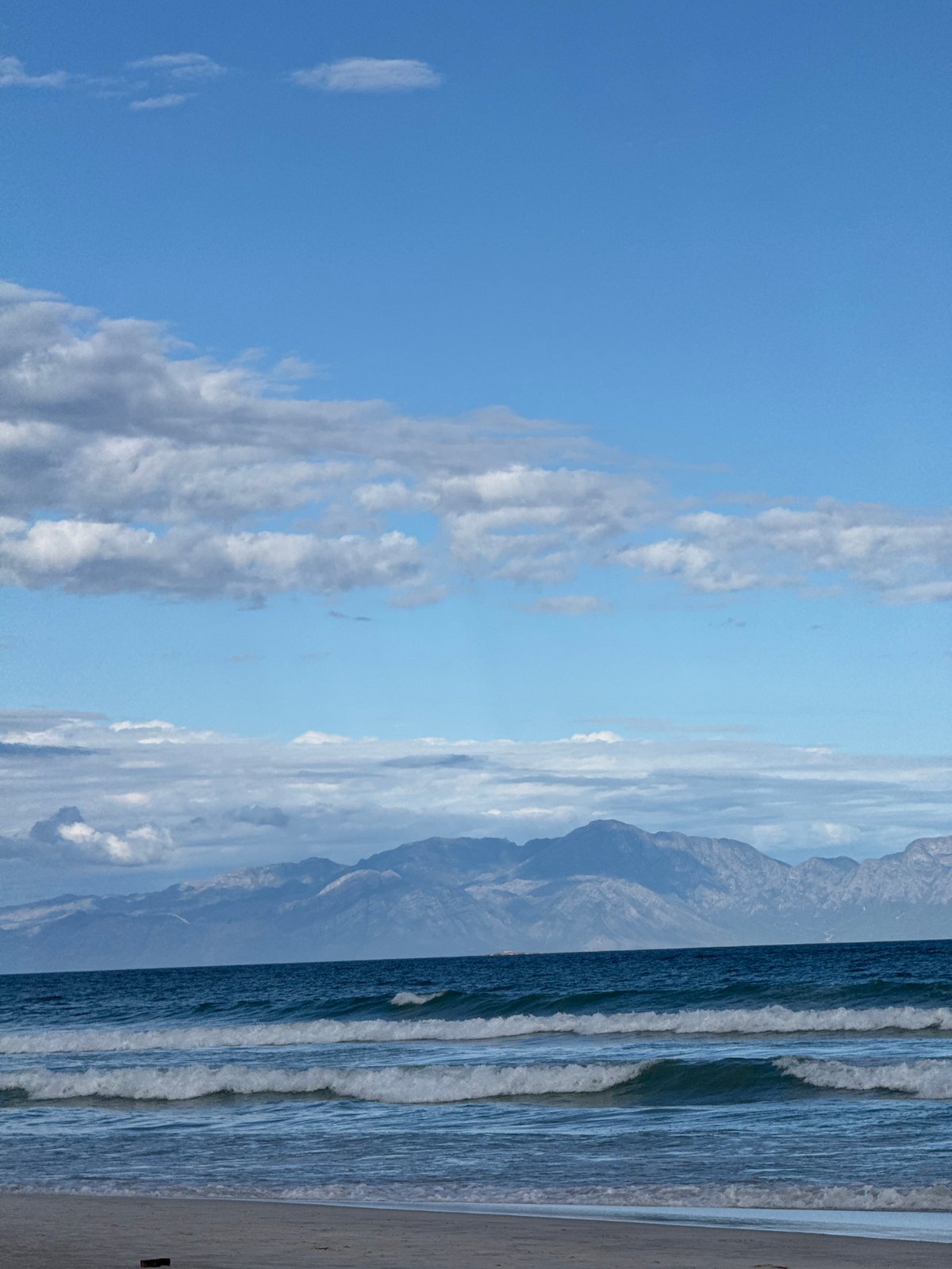 Ordinary afternoon unfolds at Muizenberg Beach, Cape Town