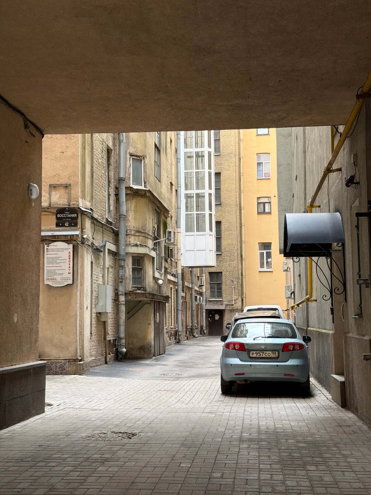 Courtyard scenes documented in Saint Petersburg featuring gated alleyway