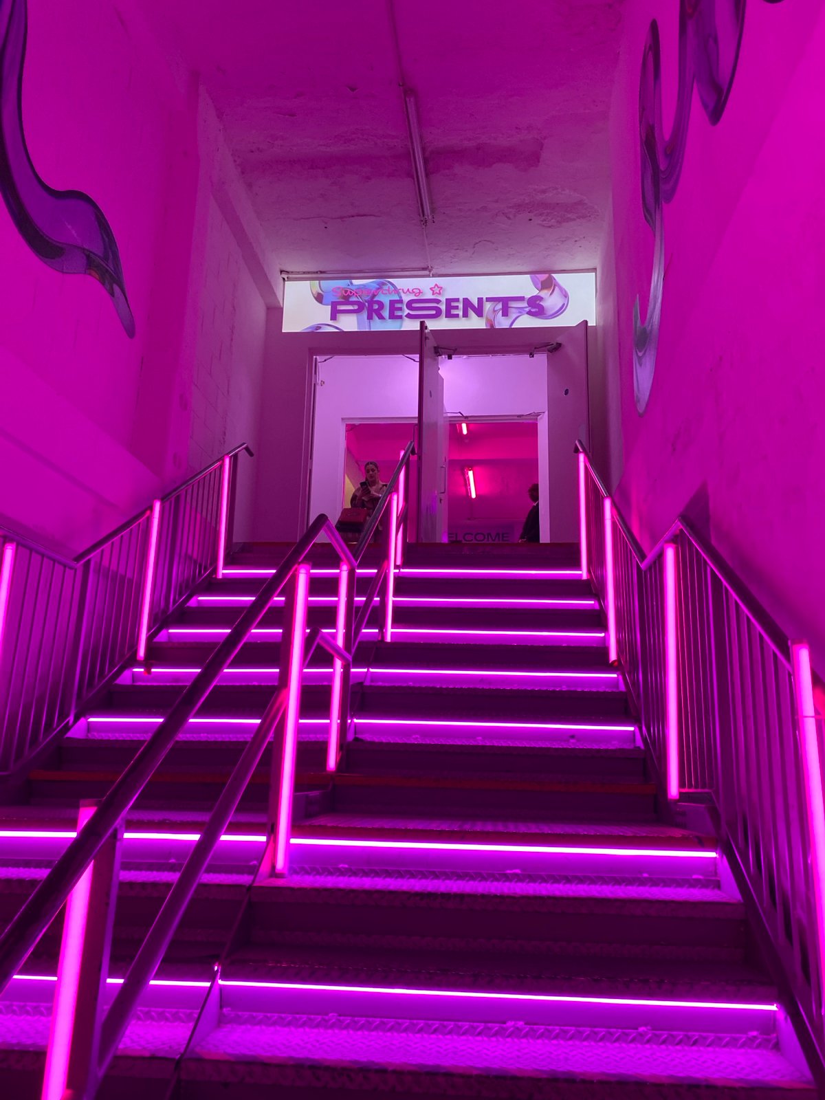 Person photographed in pink-lit London venue