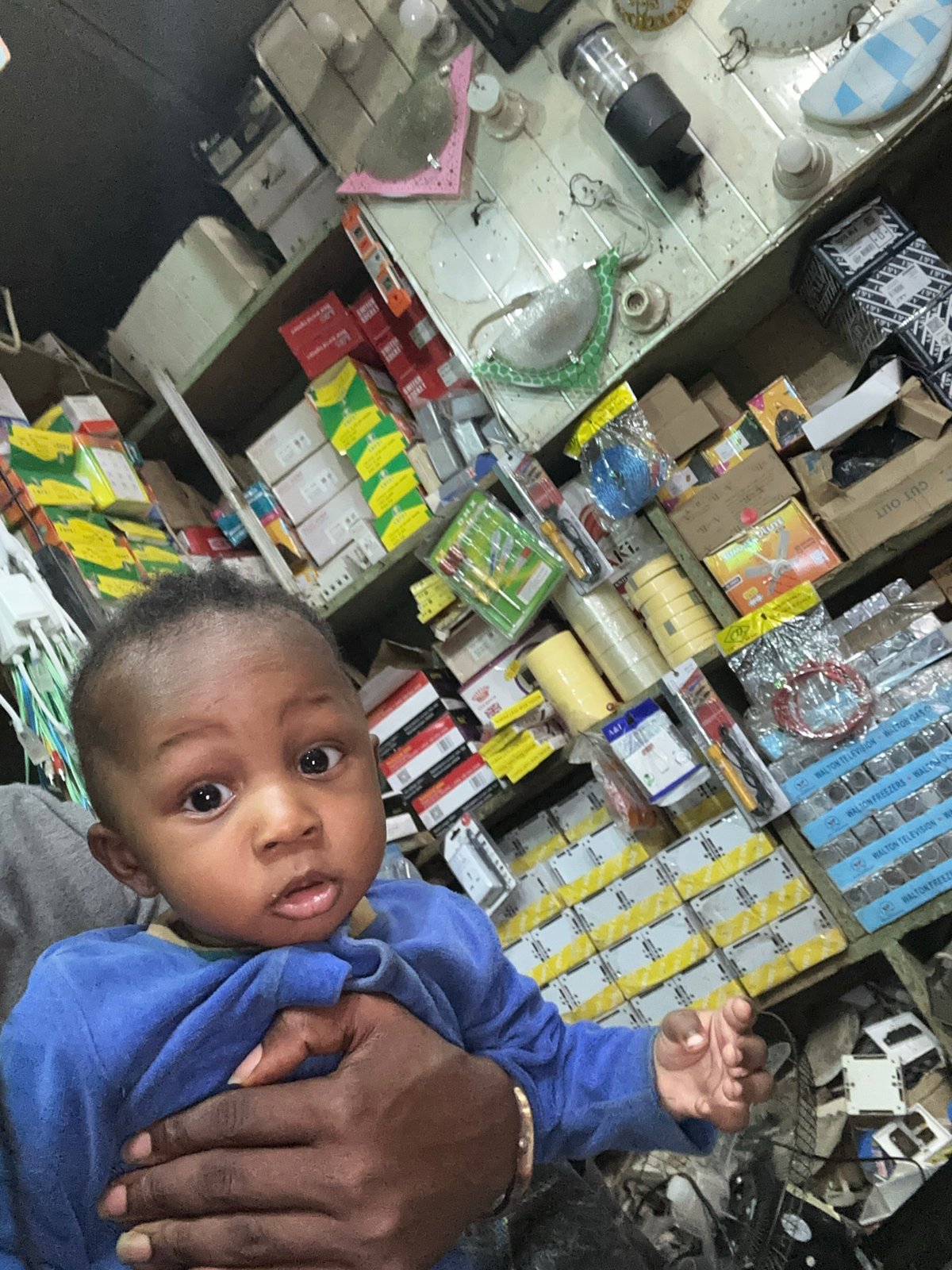 Family visits electronics shop in Narayi, Nigeria