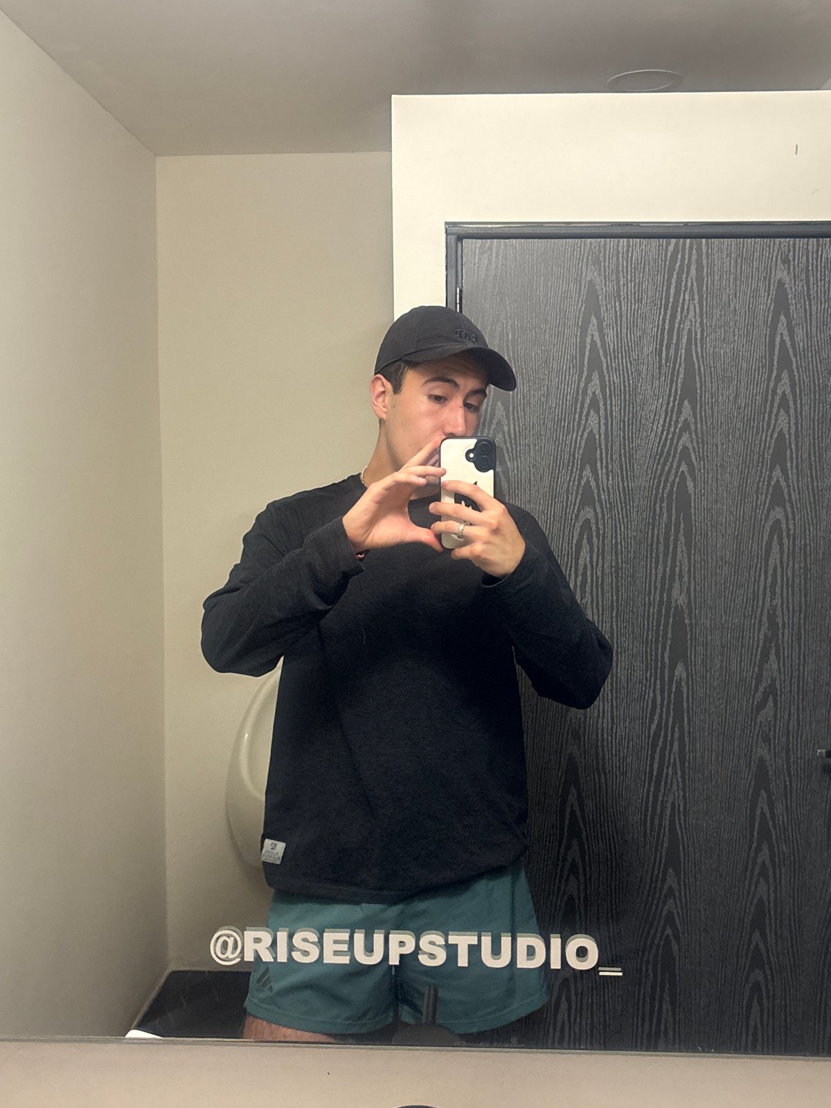 Young man takes mirror selfies in Mexican bathroom