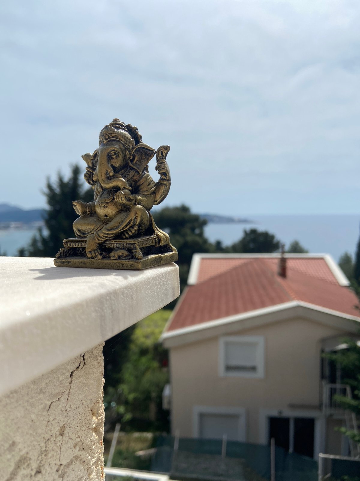 Toy figurines photographed on ledge overlooking Montenegro coast