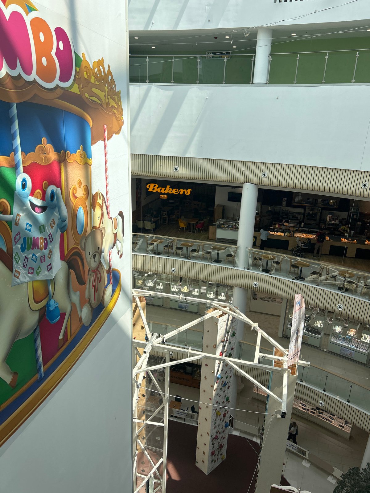 Shopping mall interior with carousel mural observed in Plovdiv