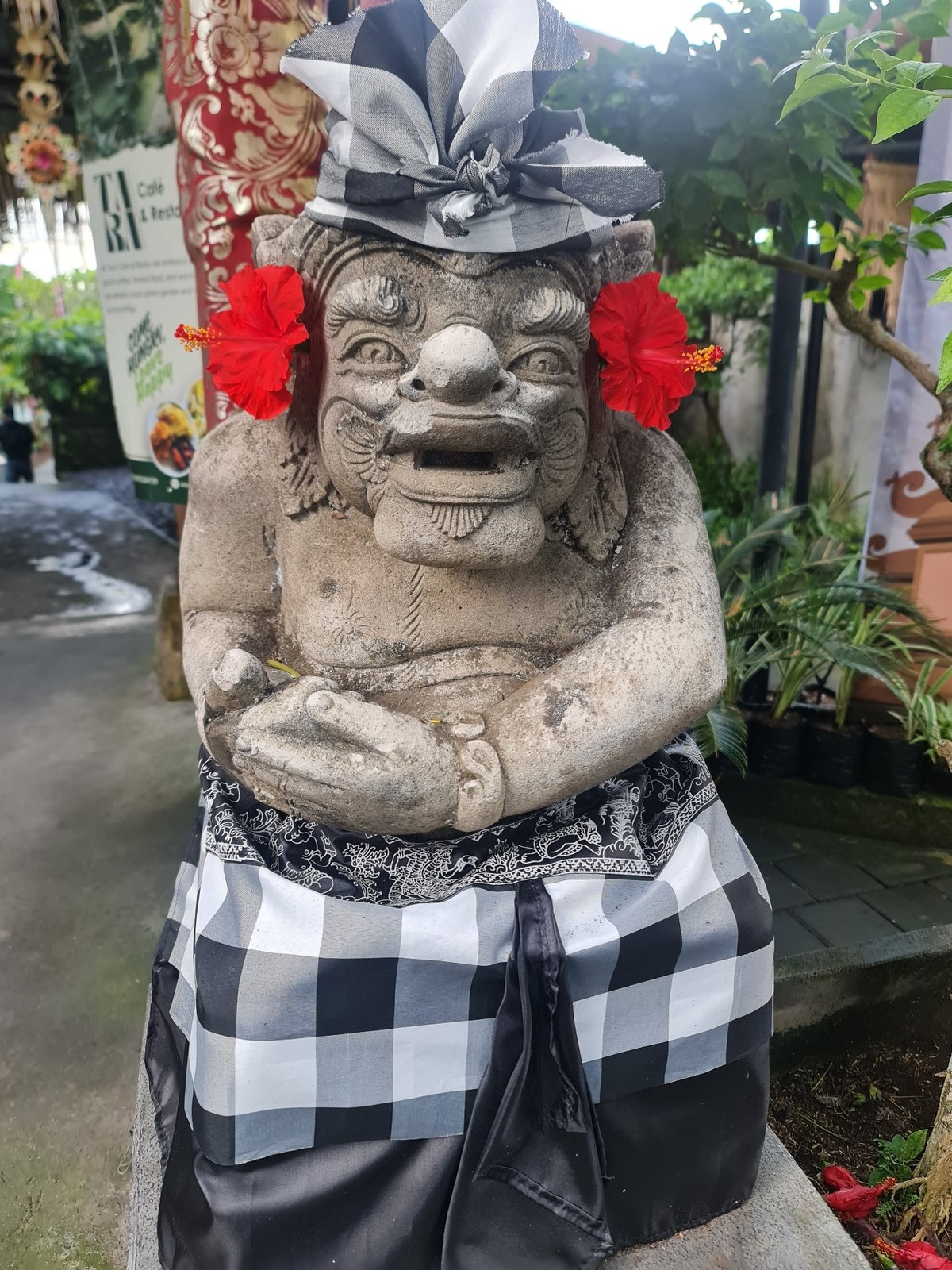 Balinese demon statues with ceremonial decorations in Gianyar