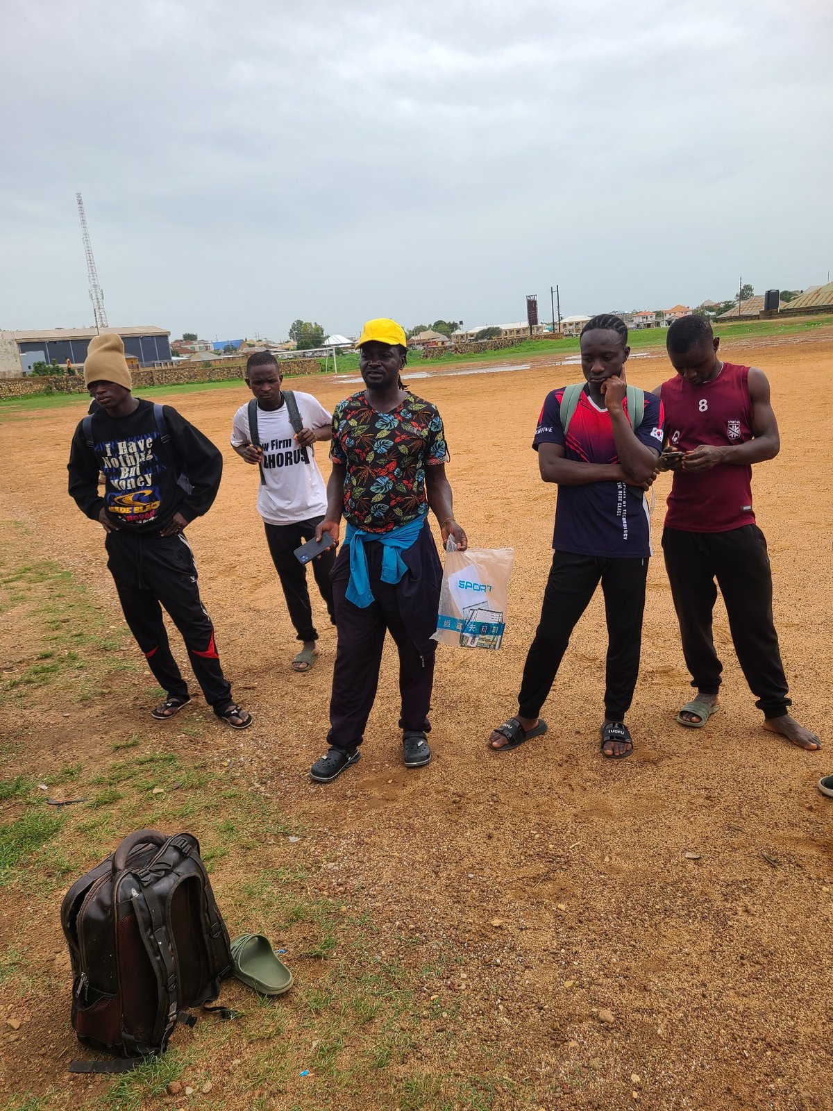 Young men gather at urban sports field wearing jerseys