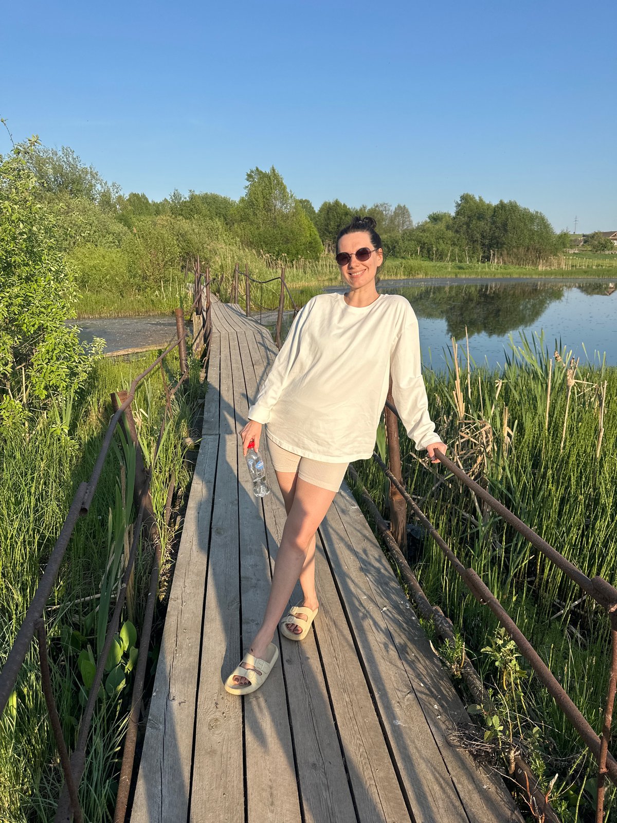 Woman photographed at lakeside boardwalk in Альняш, Russia