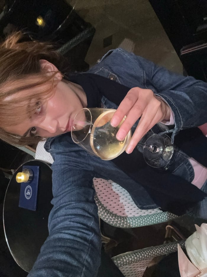 Two women share wine and conversation at Paris cafe