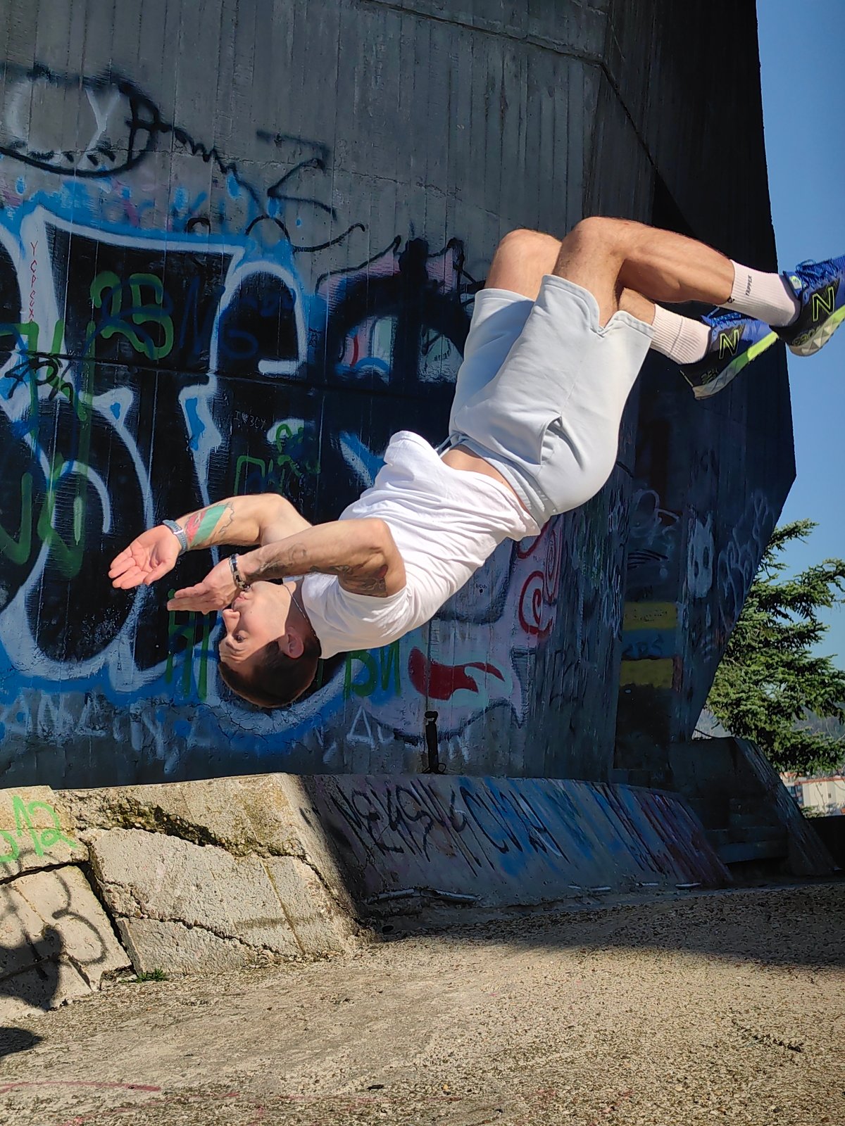 Man performs parkour stunts near graffiti in Varna