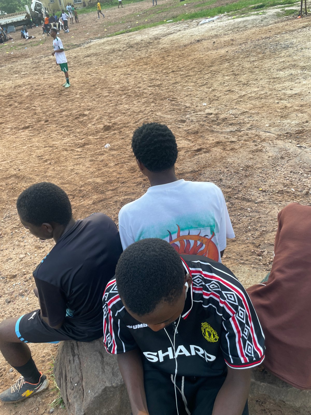 Pickup football on a dirt field in Lokoja, Nigeria