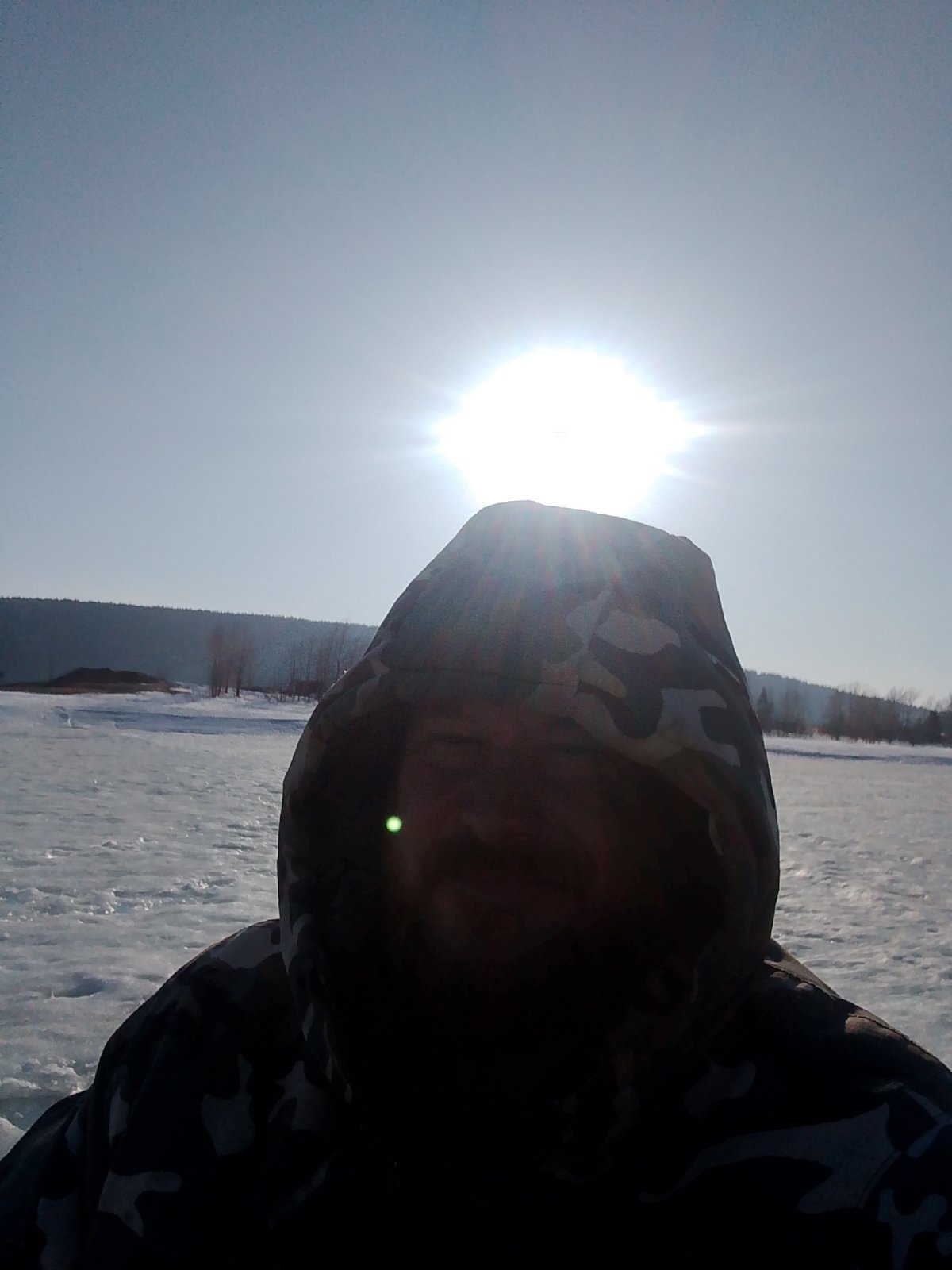 Ice fishing scene documented on frozen lake near Noviy, Russia