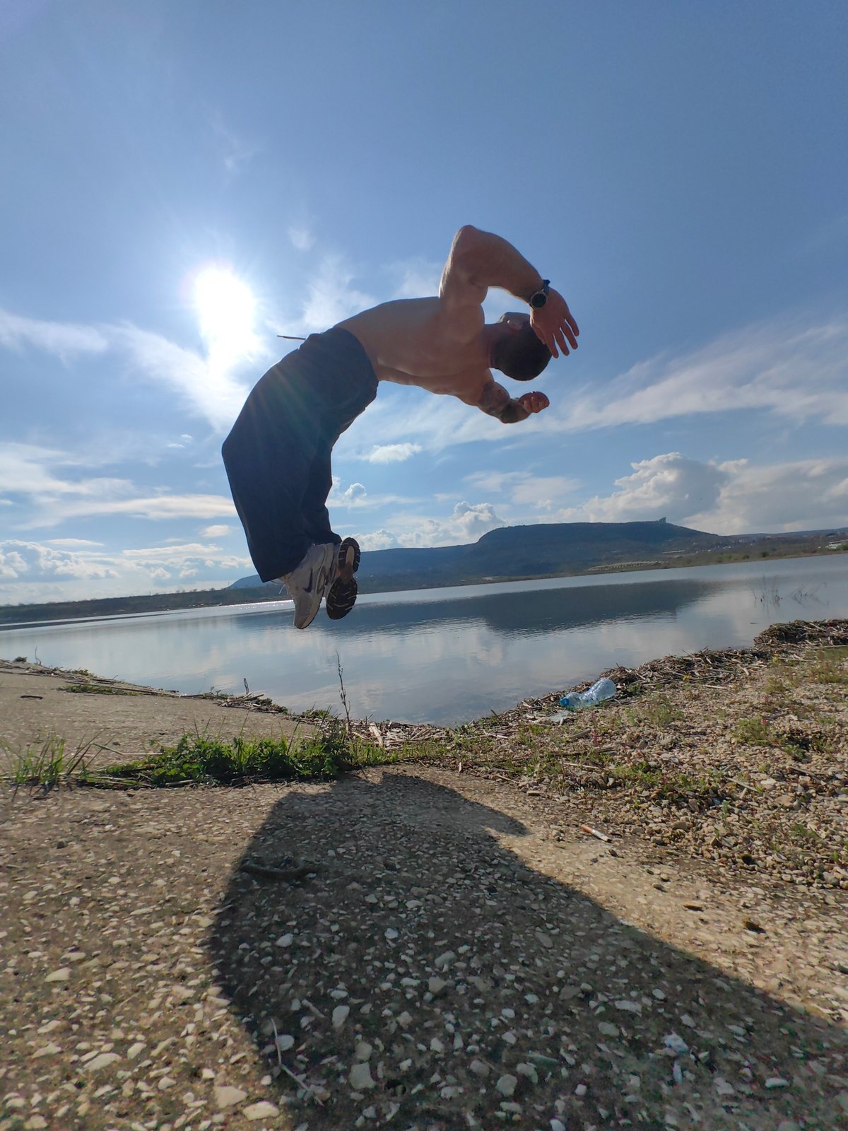 Man splashes water from concrete bank edge