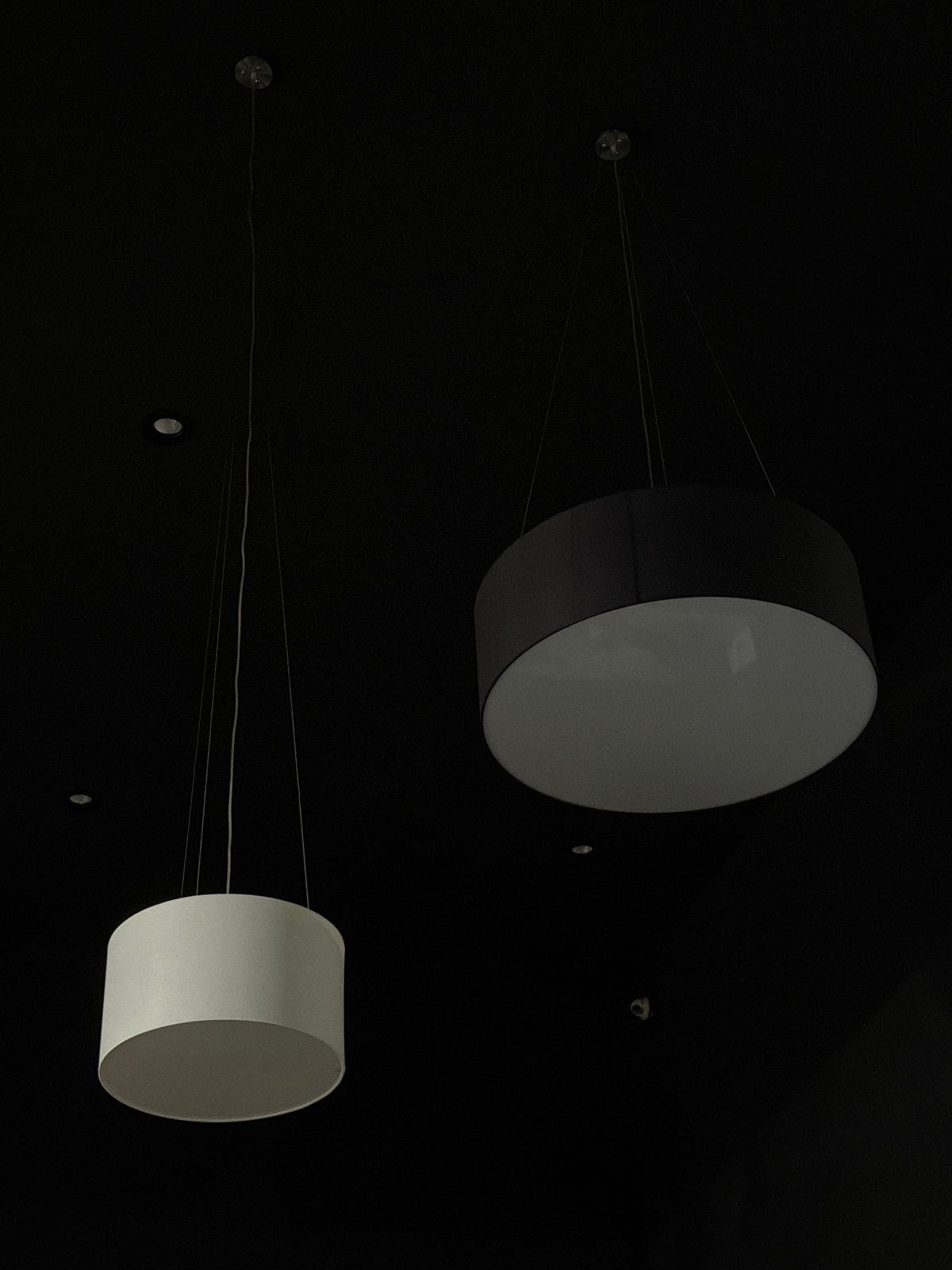 Cylindrical light fixtures observed in dark Izhevsk interior