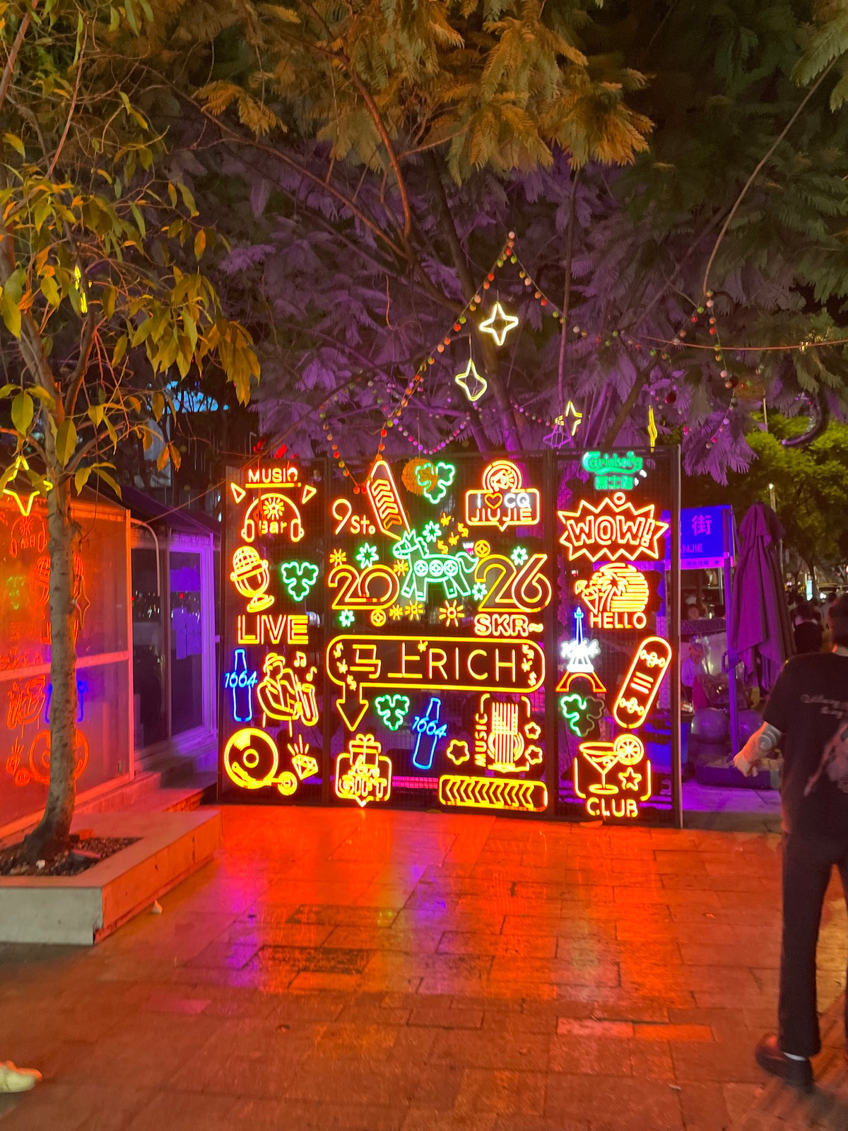 Neon-lit commercial streets of Liangjiang on a summer night