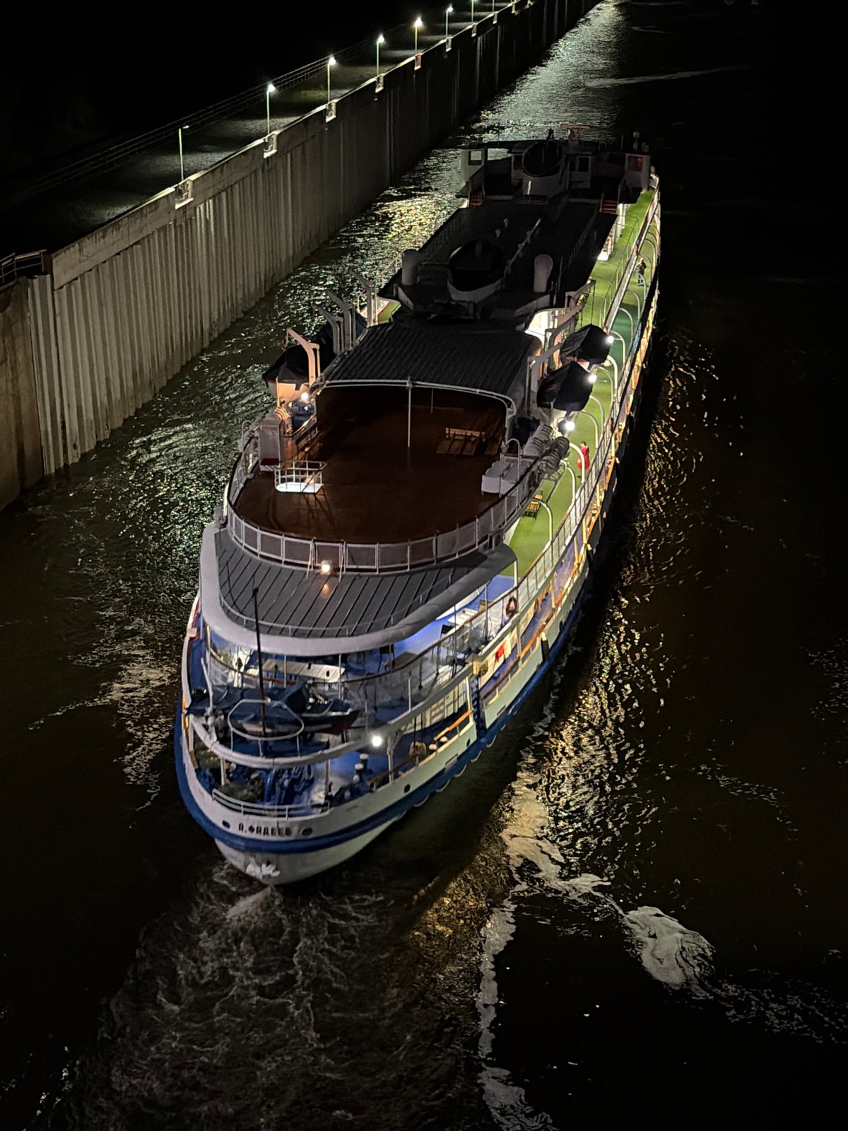 River cruise ships transit Chaikovsky locks during evening hours