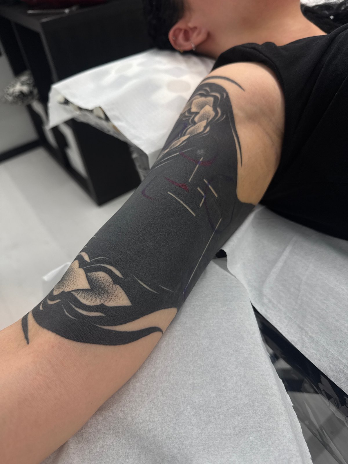 Person gets elaborate floral tattoo sleeve in Sofia studio