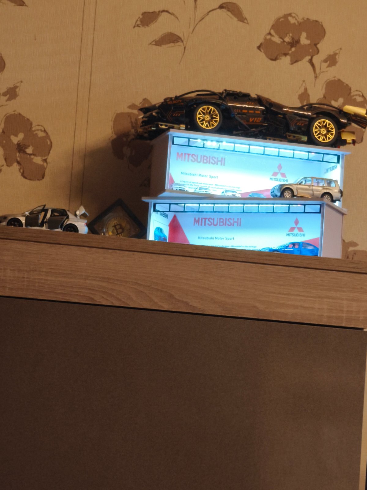 Model cars and Bitcoin coin displayed in Sofia home