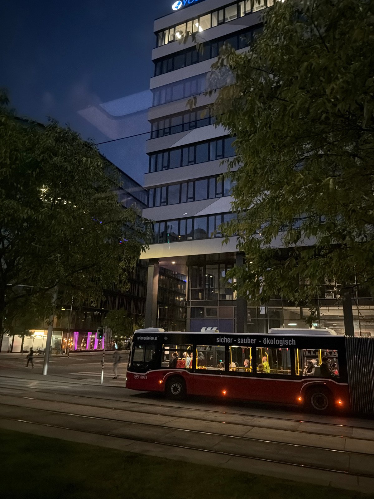 Urban building with lit windows observed at night