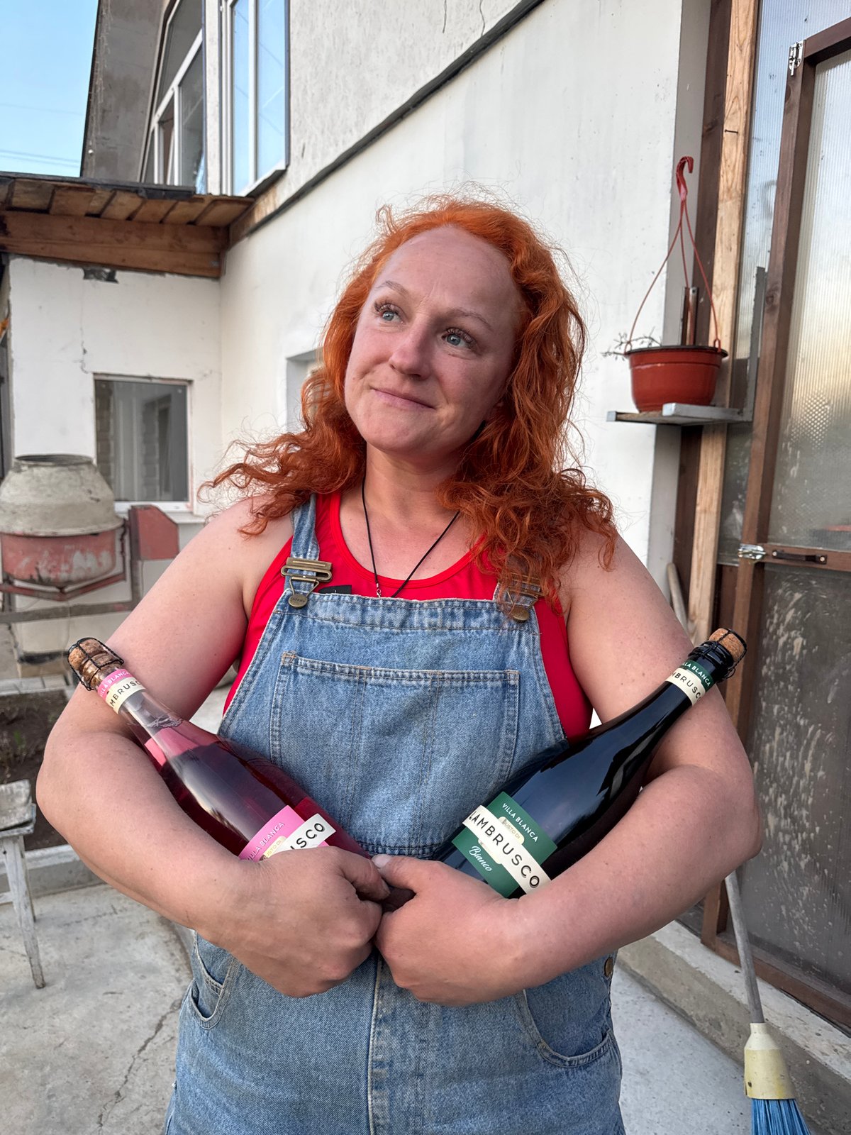 Woman cooks outdoor meal with wine in Chaikovsky, Russia