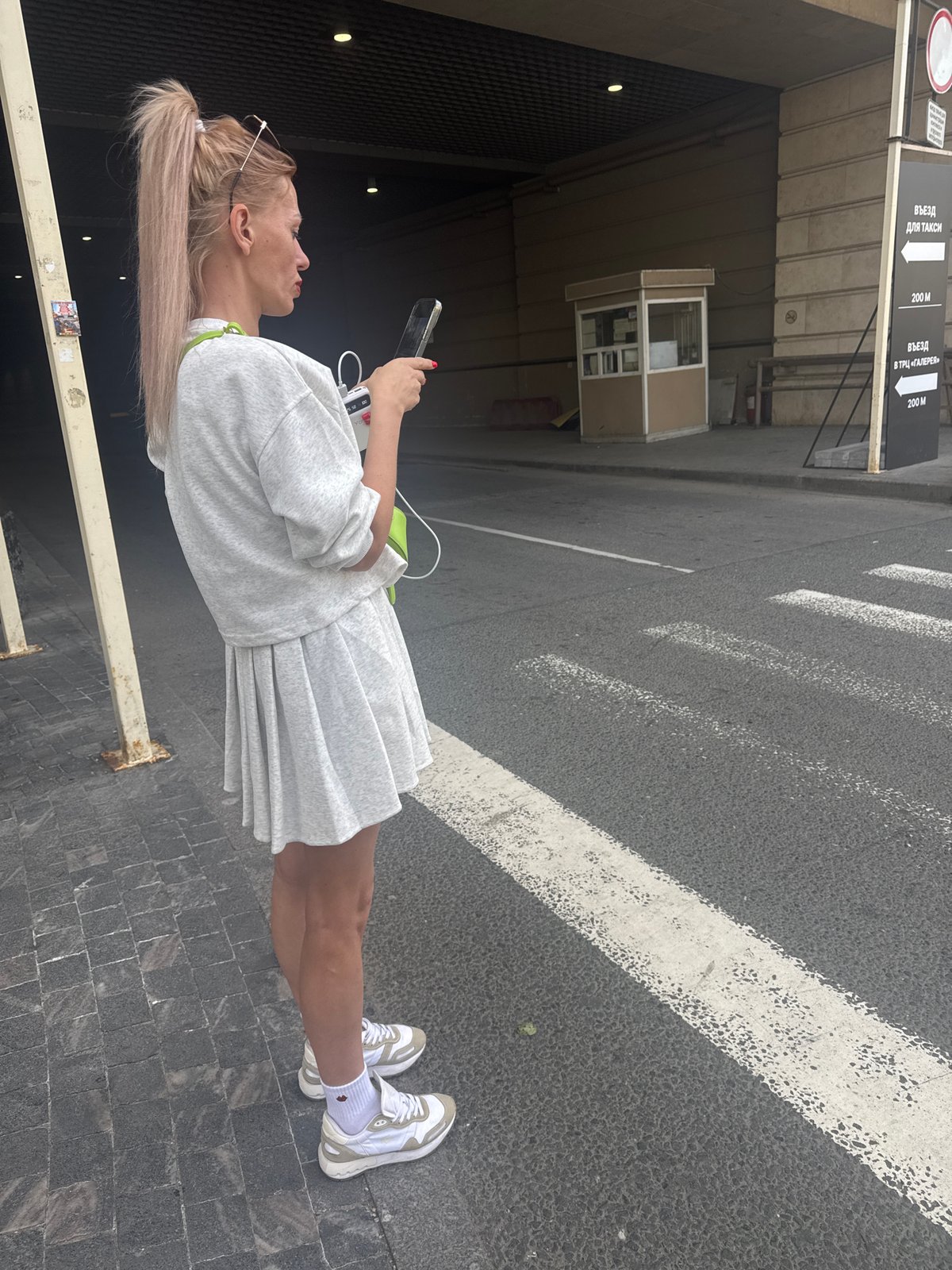 Woman takes selfies during morning walk through Saint Petersburg