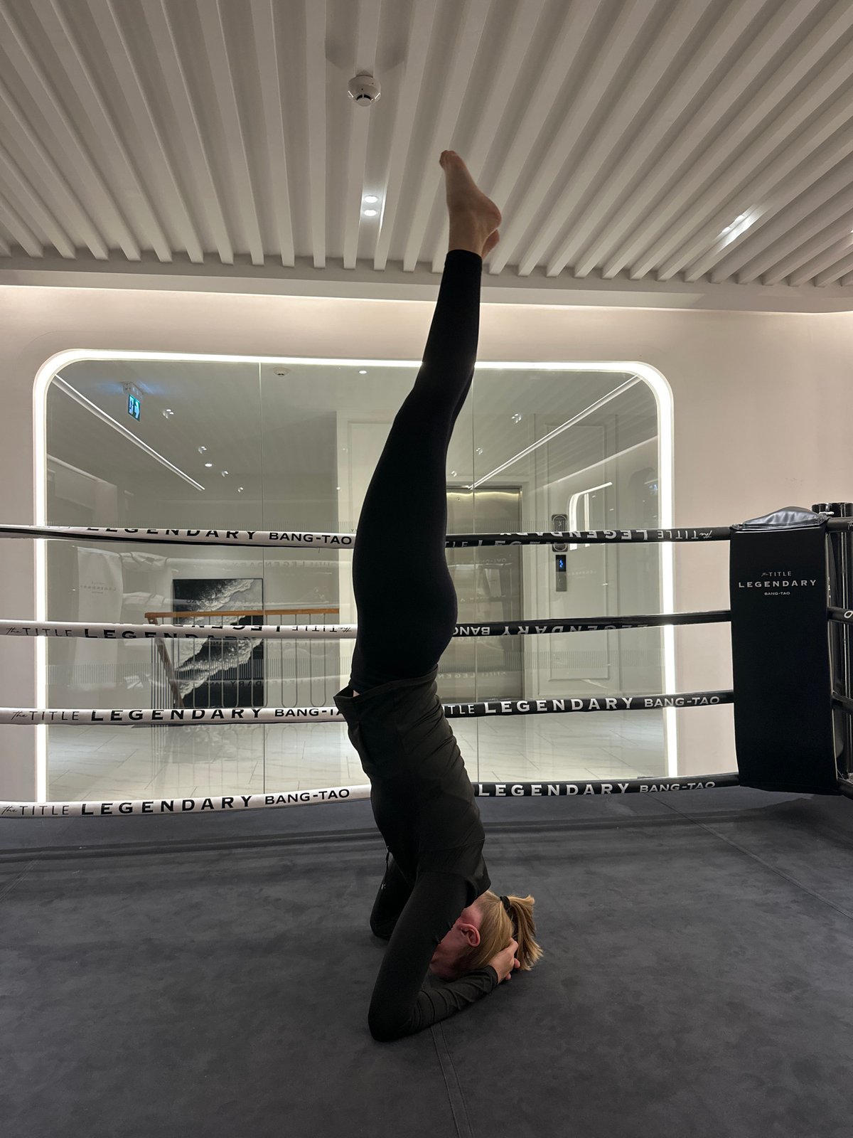 Headstand practice inside a boxing ring in Choeng Thale