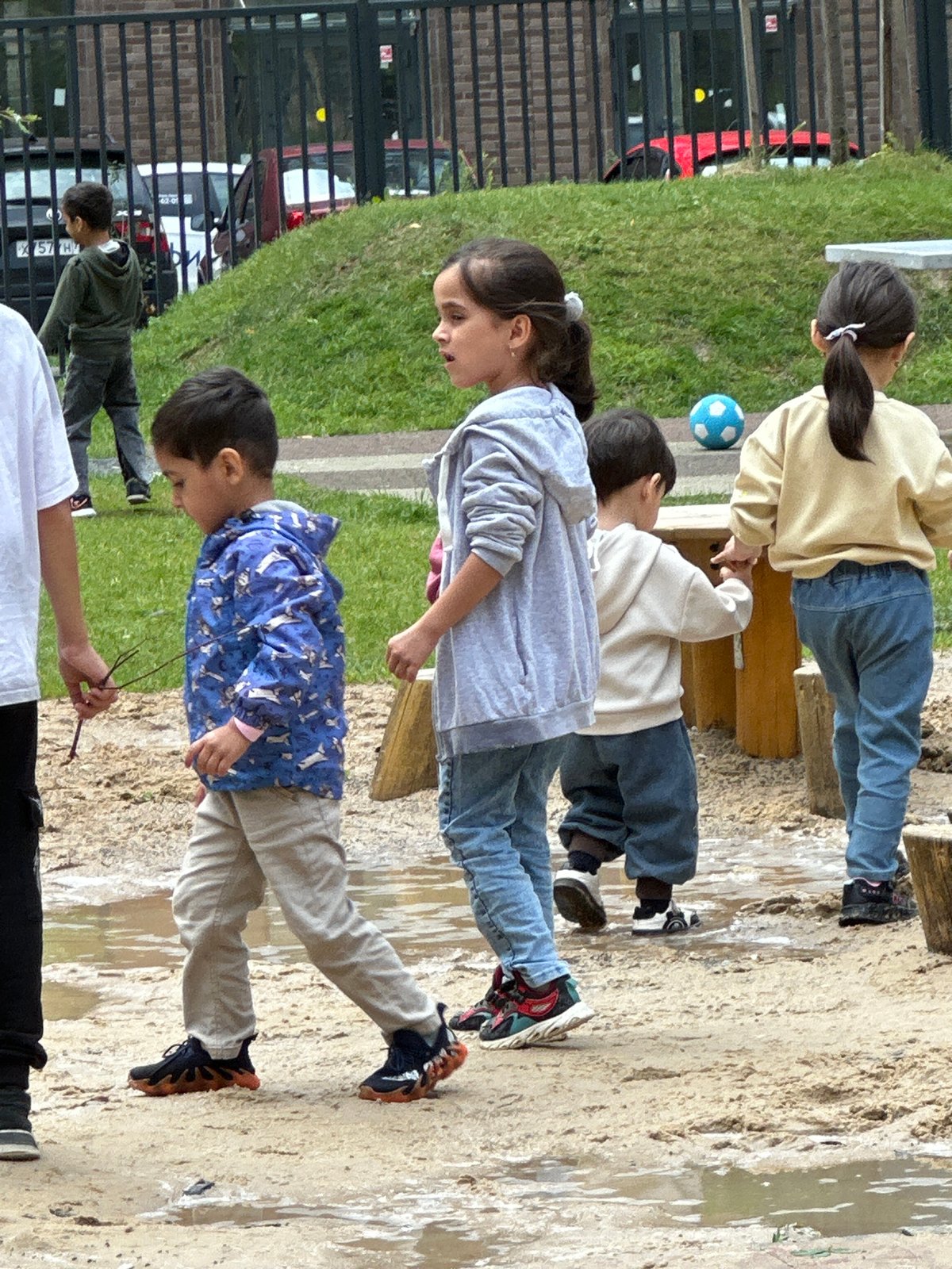 Kids at play in a Russian neighborhood playground on a summer morning