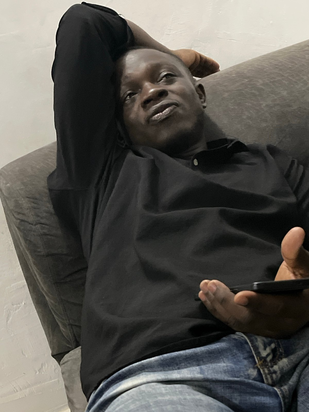 Casual evening at home in Abuja — phones, food, and downtime