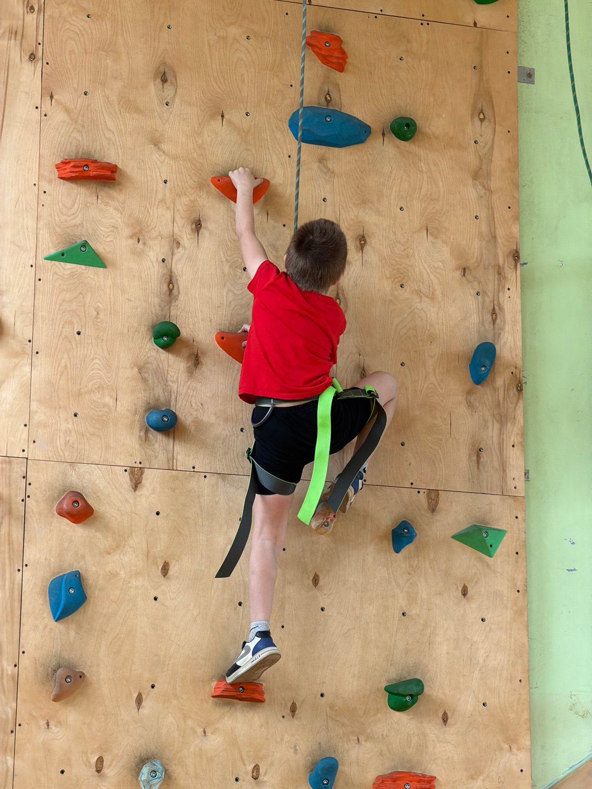 Boy rock climbs at indoor facility in Izhevsk