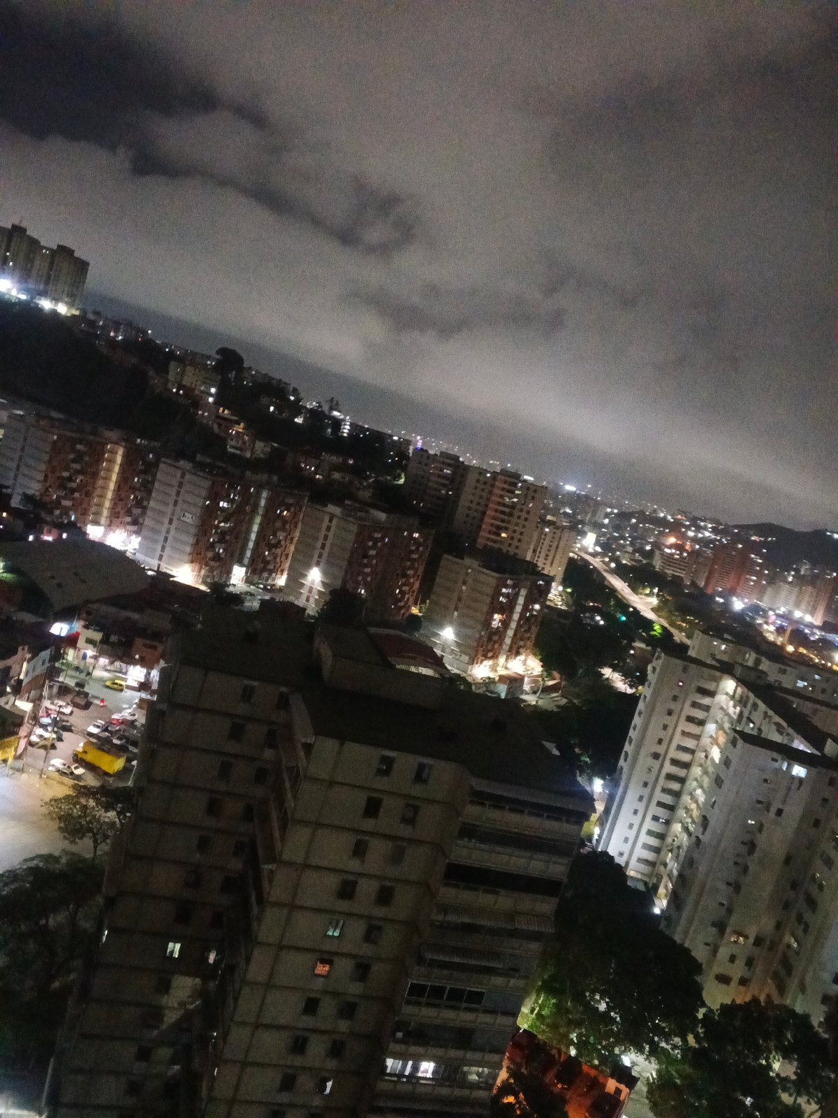 Nighttime Caracas captured from rooftops to living rooms