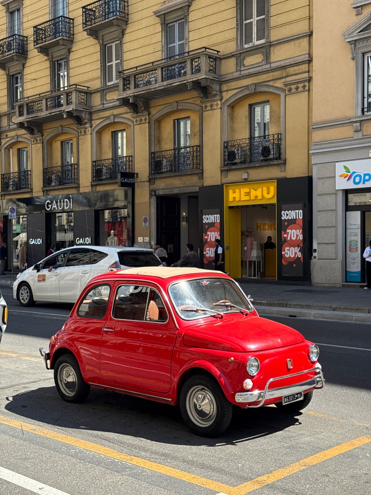 Red vintage Fiat 500 spotted parked on Milan street