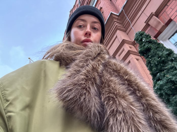 Woman photographed on overcast London street wearing winter clothing