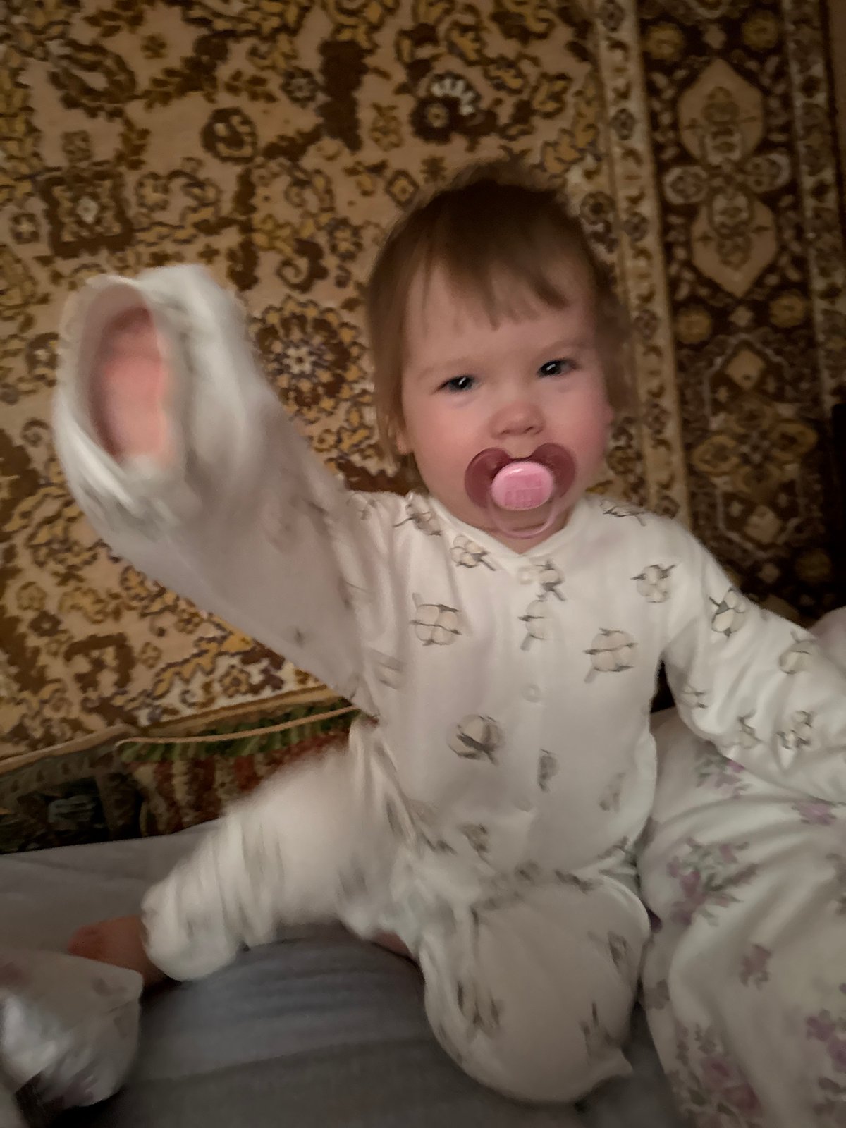 Baby rests on rug in Krapivka, Russia