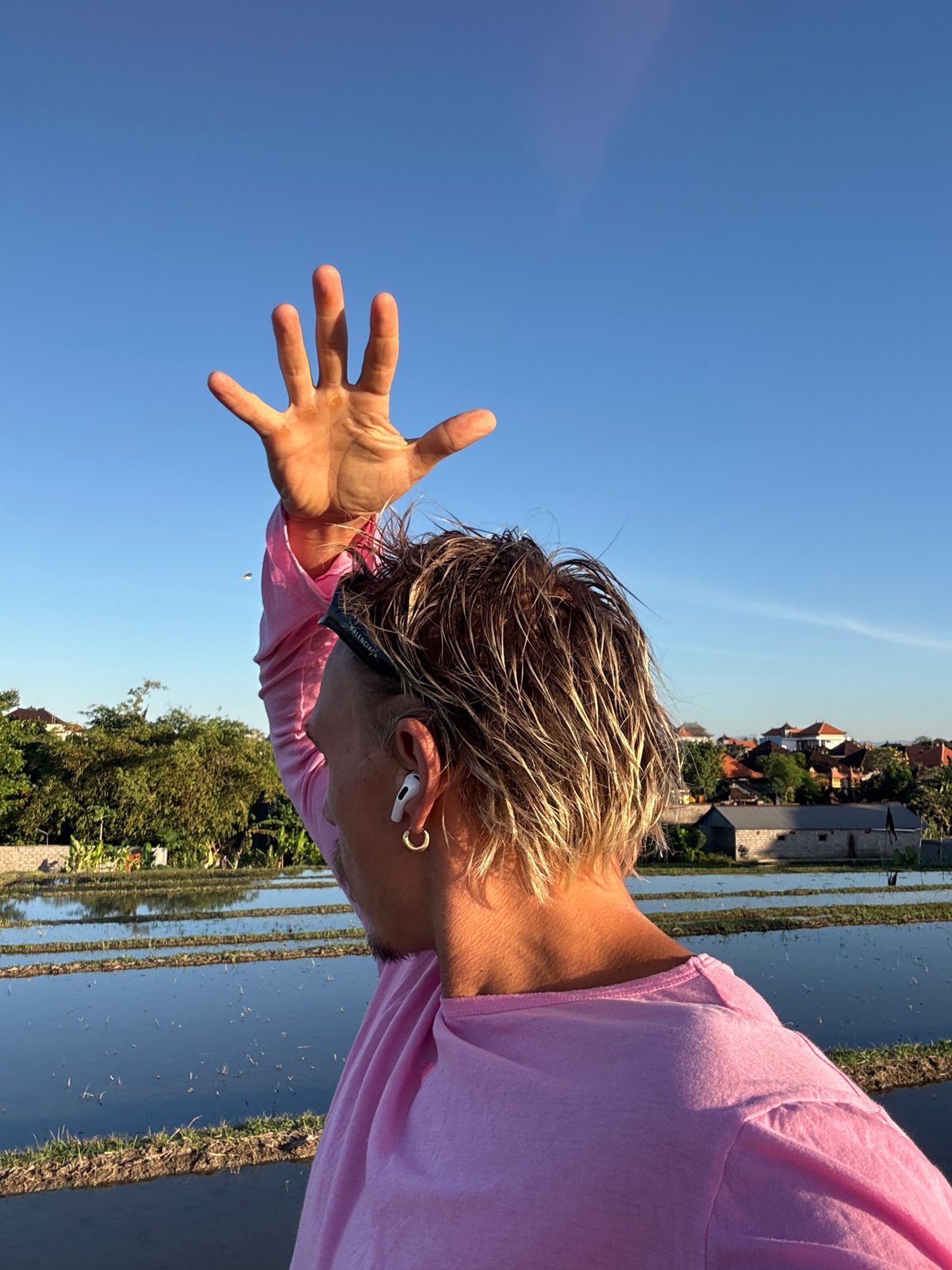 Person films content near rice paddies in Mengwi, Indonesia