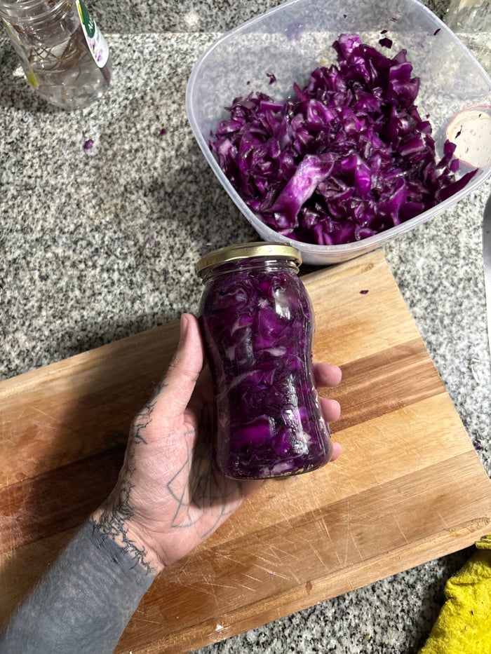 Heavily tattooed person prepares food in Buenos Aires