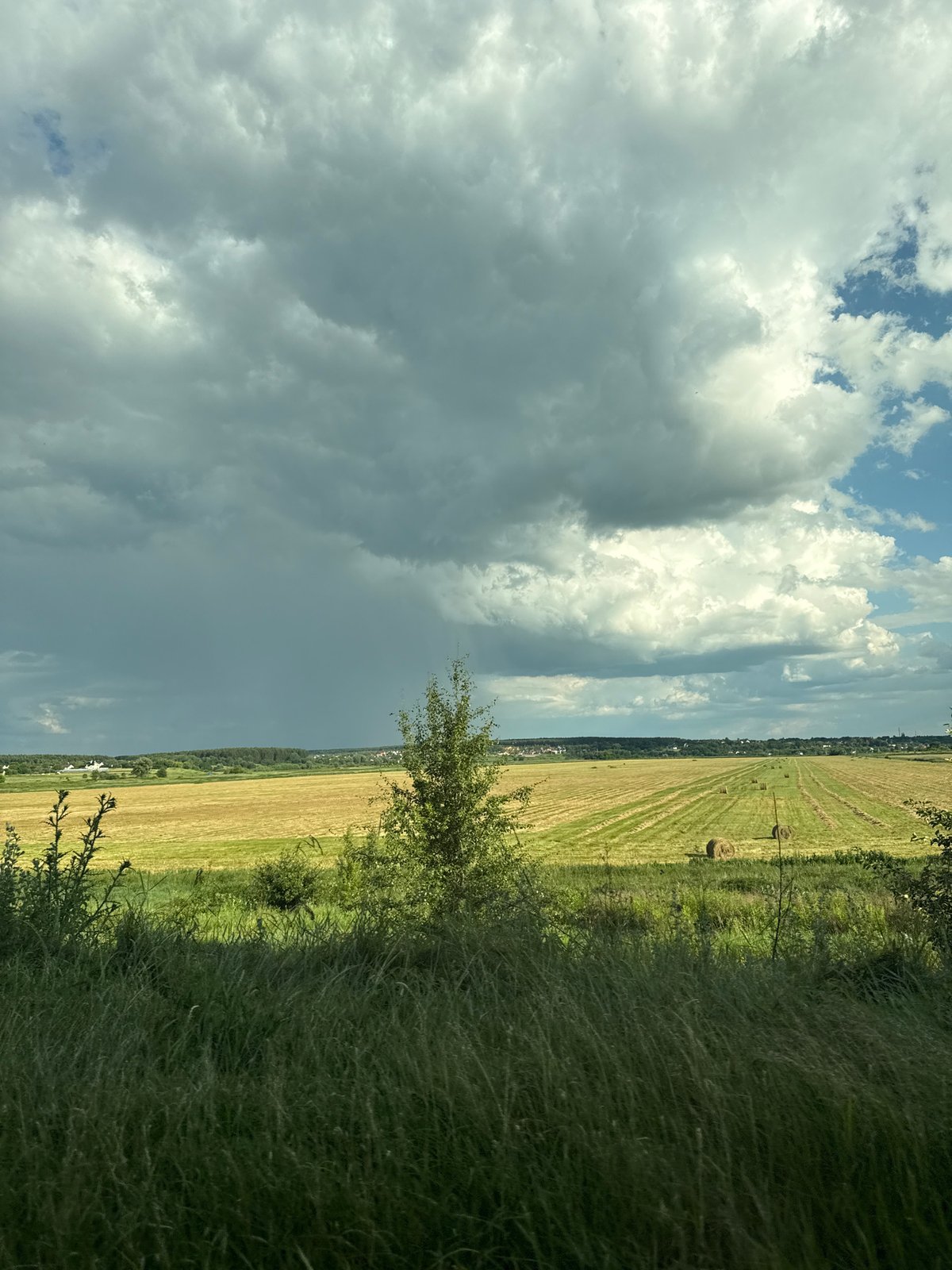 Summer storm skies over harvested fields in rural western Kyiv region