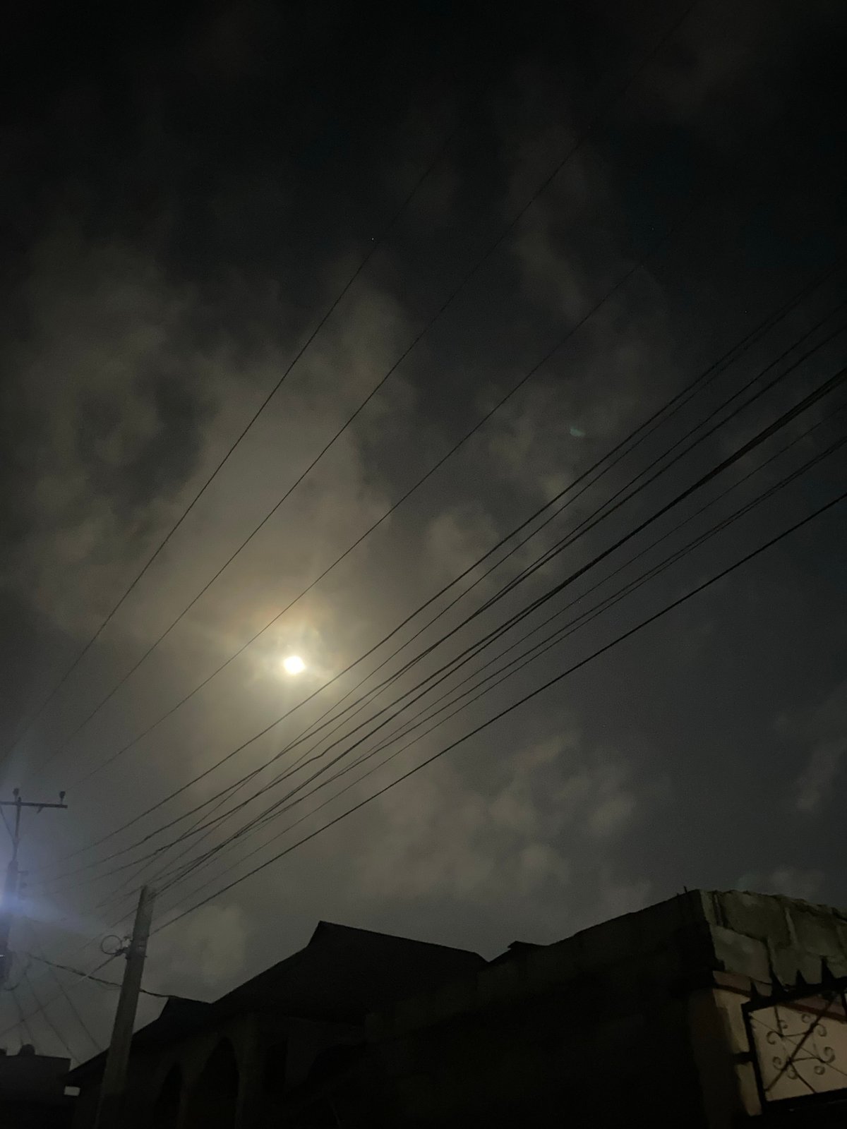Night scene captured in Lagos showing moonlight through cloudy sky