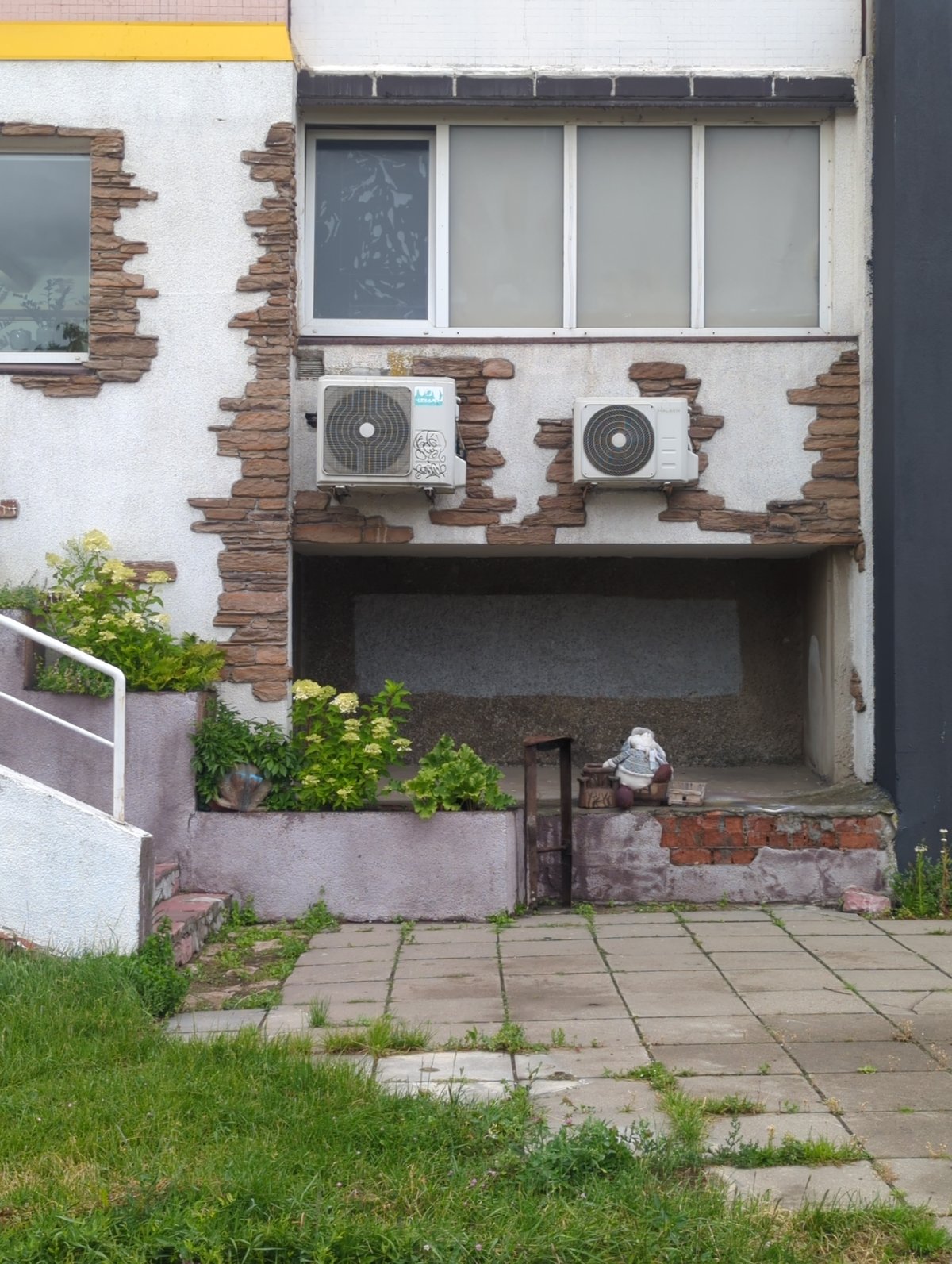 Street-level details in Minsk: a hidden doll and a sunflower bud