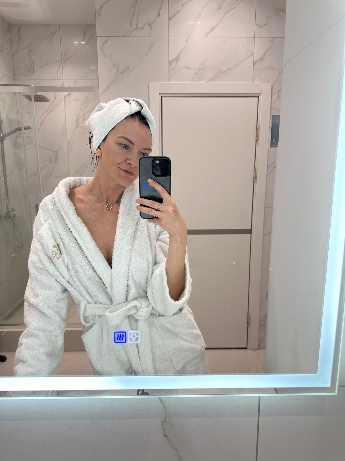 Woman takes bathroom mirror selfies in hotel robe, Russia