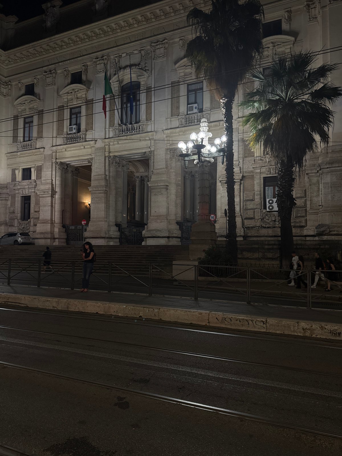 Classical Roman building with Italian flag photographed at night
