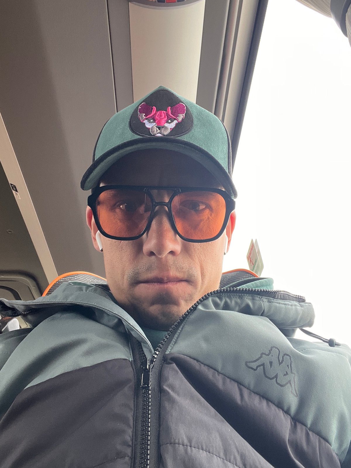 Man in green cap photographed on public transport in Chaikovsky