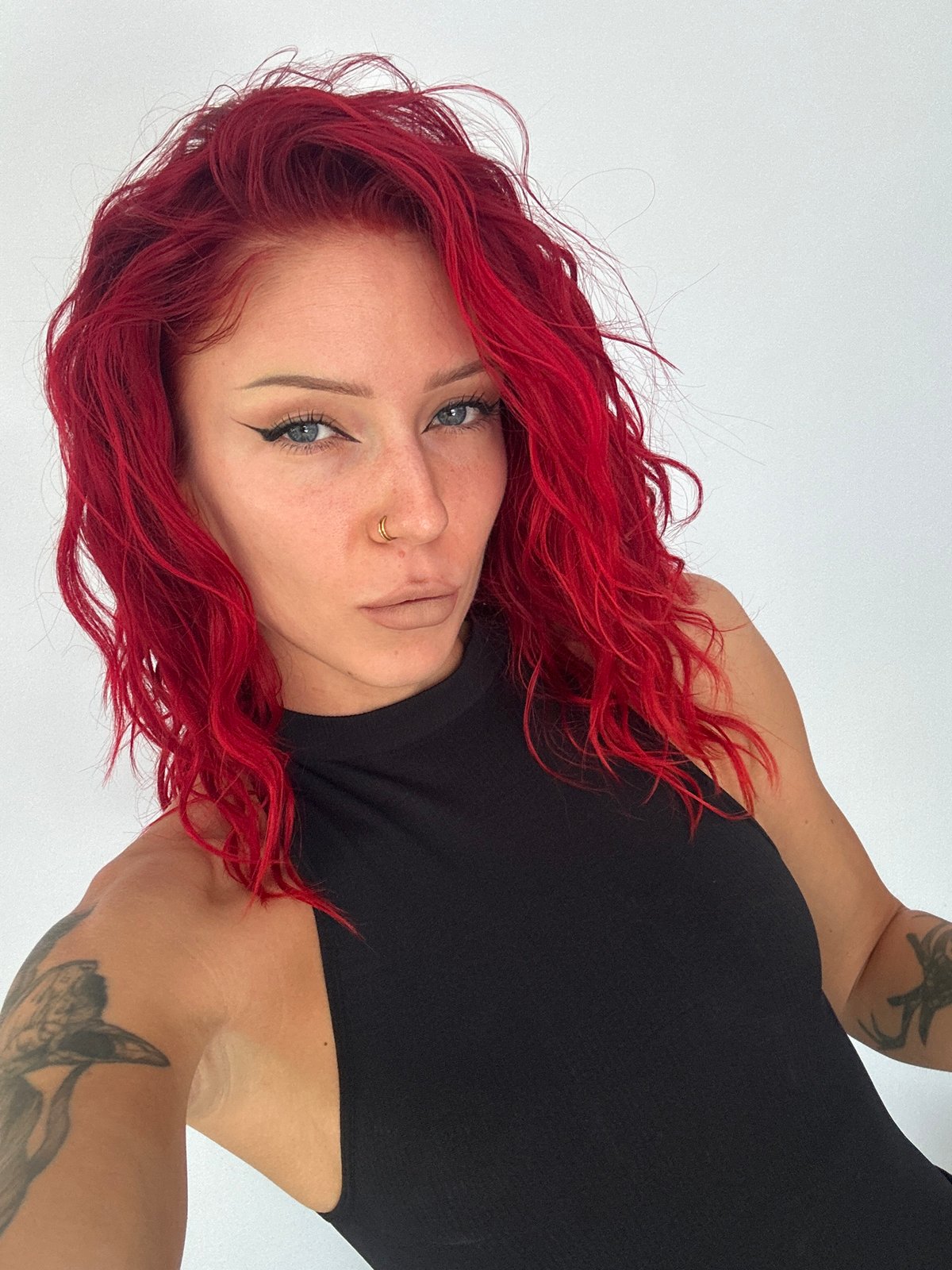Red-haired woman with gold nose ring observed in North Kuta