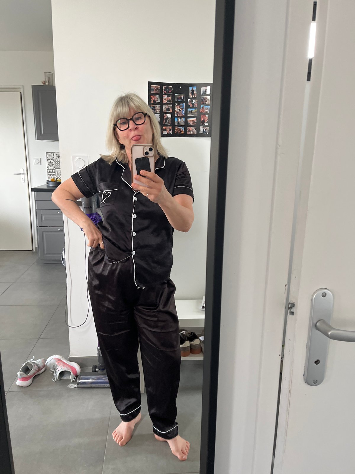 Woman takes playful mirror selfie in pajamas