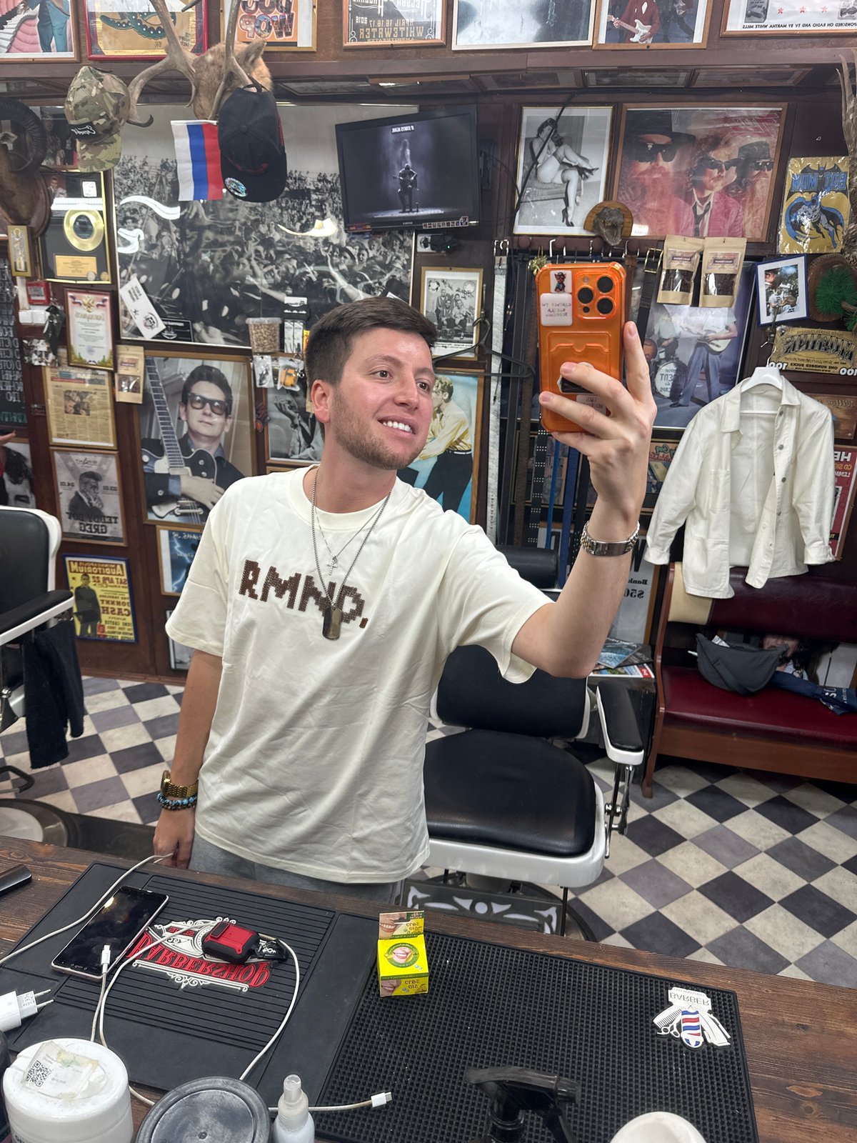 Man documents barbershop visit with selfies in cluttered Moscow establishment